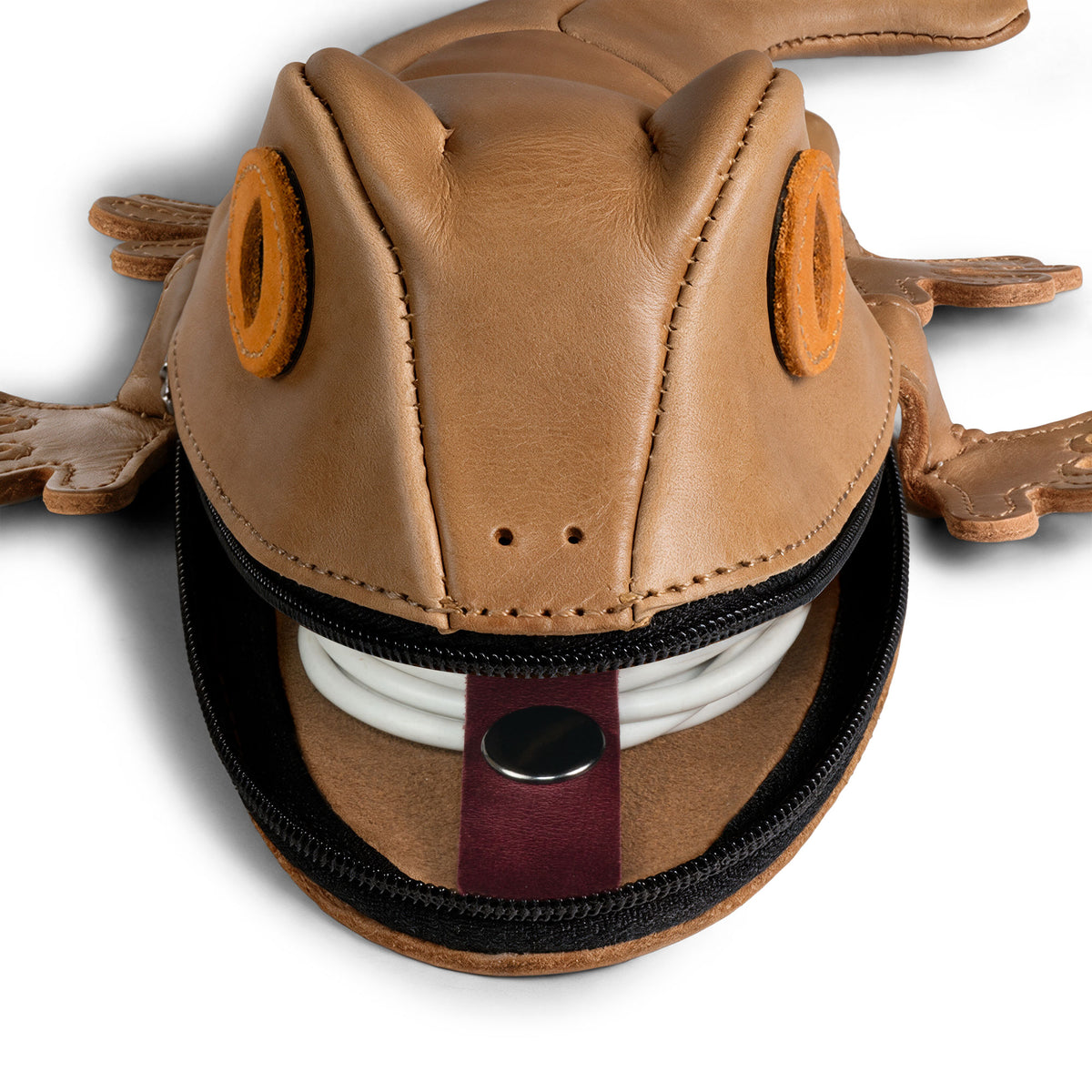 Close-up of the Tudi Frudi Gecko Pouch holding coiled earbuds or cable accessories, demonstrating a Gecko Pencil Pouch, Small Pen Organizer, Zippered Holder Wallet for Coins, Change Purse, and Money Pouches for Men and Women; its Full Grain Leather Cable Holder showcases StockyardX Small Batch Production with Hand Cut, Hand Sewn, Fire Branded Artisan details, Handmade in La Antigua Guatemala & Oaxaca Mexico.