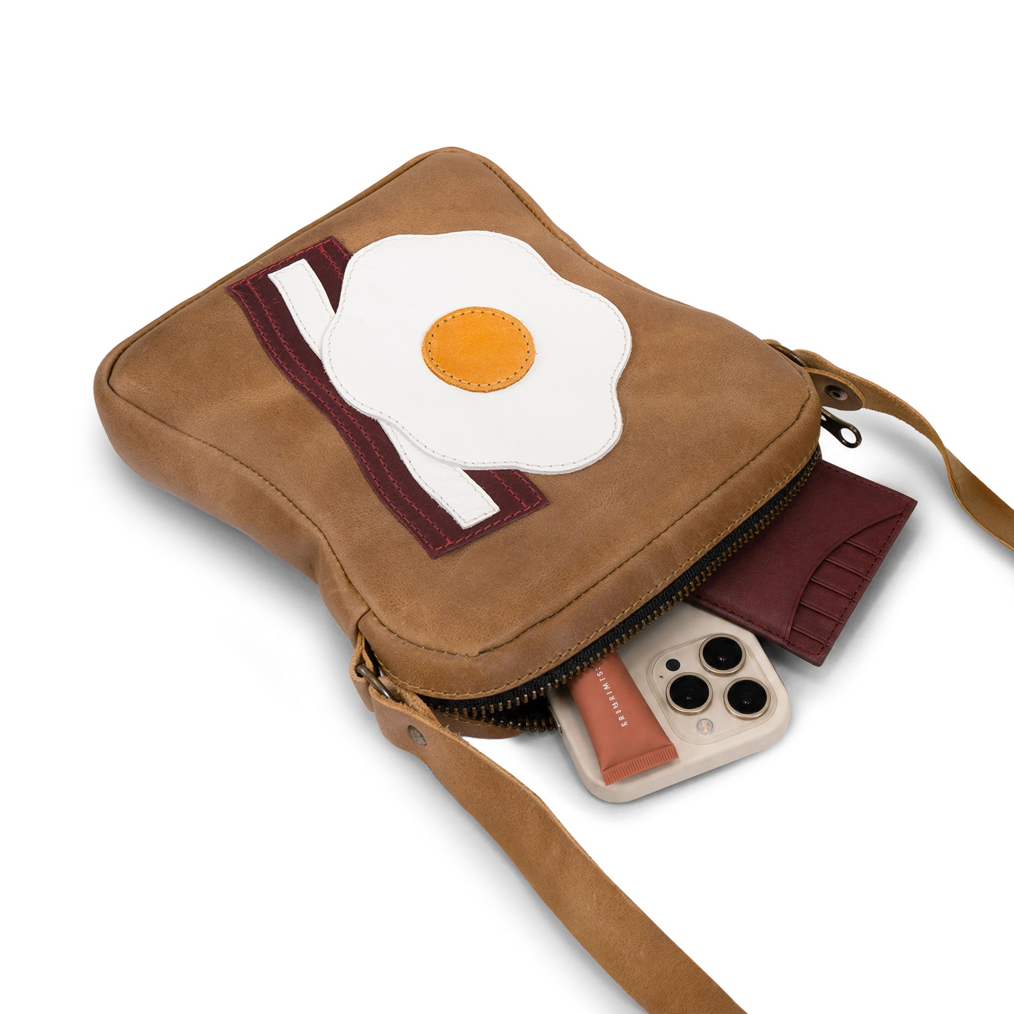Interior view of the Egg and Bacon Sandwich-Shaped Shoulder Bag by Tudi Frudi, highlighting its practical design and spaciousness. This Handbag, Crossbody Bag, or Messenger Bag is made from Full Grain Leather, showcasing artisan craftsmanship with Hand Cut and Hand Sewn details, made in La Antigua Guatemala.