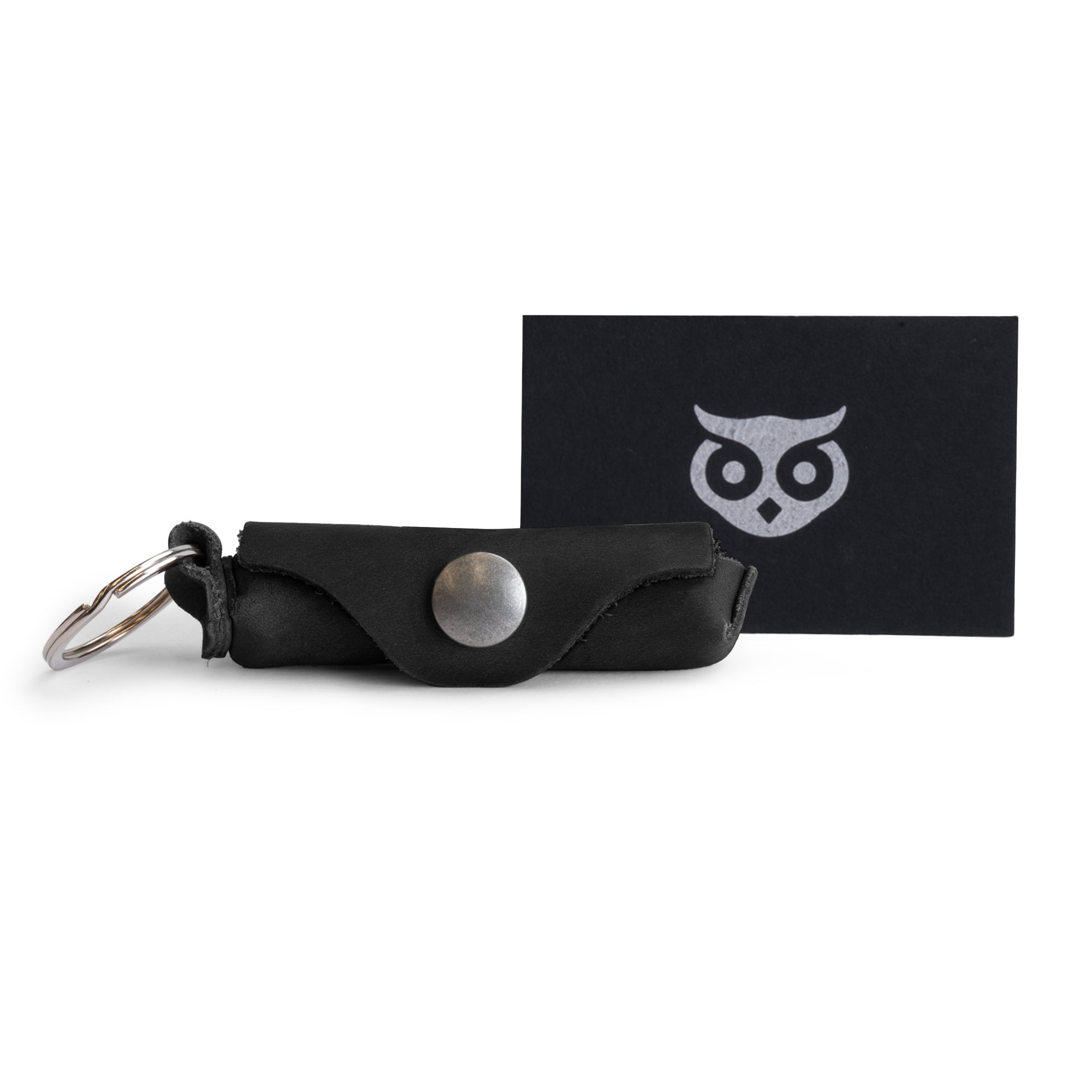 Showcasing the Hide & Drink Lip Balm Key Chain, a classic vintage lip balm keychain holder, handcrafted from full grain leather with a brass metal clasp. Perfect for lip protection, this artisan piece is made in La Antigua Guatemala & Oaxaca Mexico.