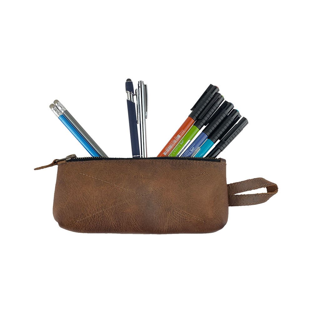 Hide & Drink's X Stitched Case, a practical and stylish storage solution for pens and small personal items, crafted from full grain leather. Made by artisans in La Antigua Guatemala and Oaxaca, Mexico, this handmade item emphasizes small batch production.