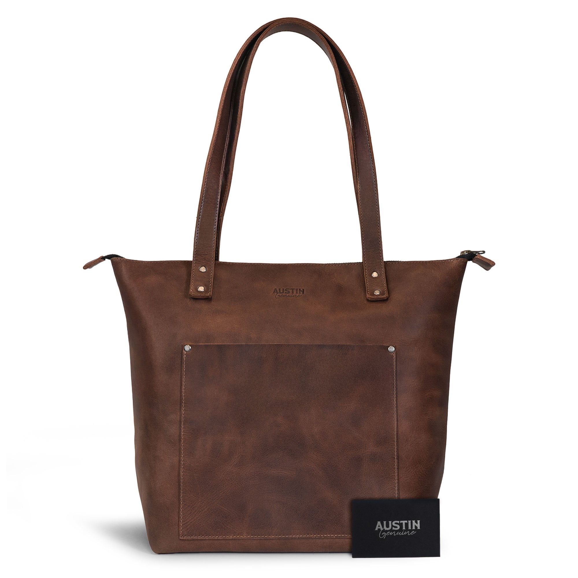 The Juniper Zippered Tote Bag presented alongside an Austin Genuine tag, emphasizing its artisan quality and handmade process. This full grain leather tote celebrates Austin’s vibrant culture and spirit, crafted with care in La Antigua Guatemala and Oaxaca Mexico.