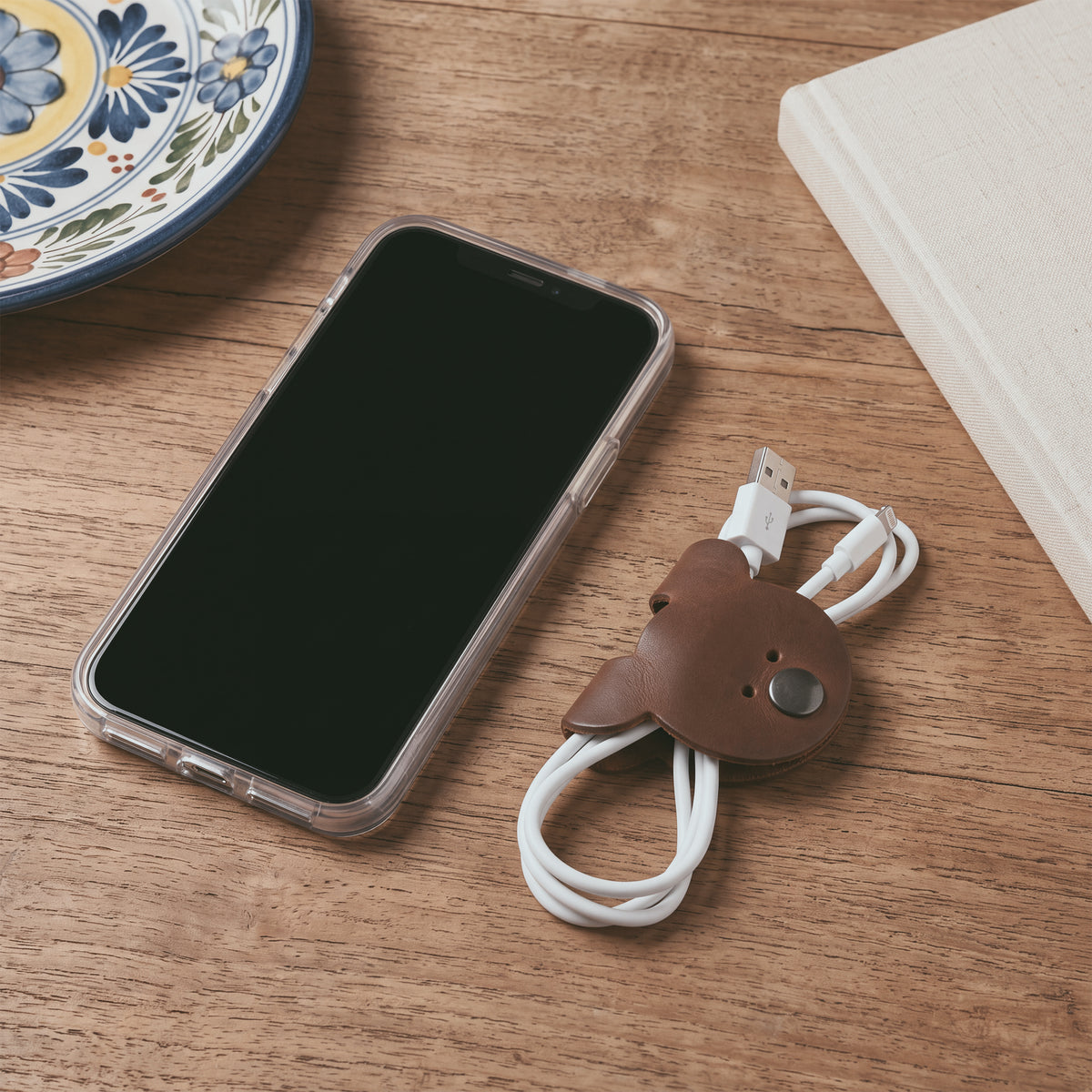 Dimensions and close-up of a Bear Shaped Cord Keeper (Cord Clam) by Hide & Drink, showcasing craftsmanship in Full Grain Leather. Handmade in La Antigua Guatemala & Oaxaca Mexico, representing small batch production.