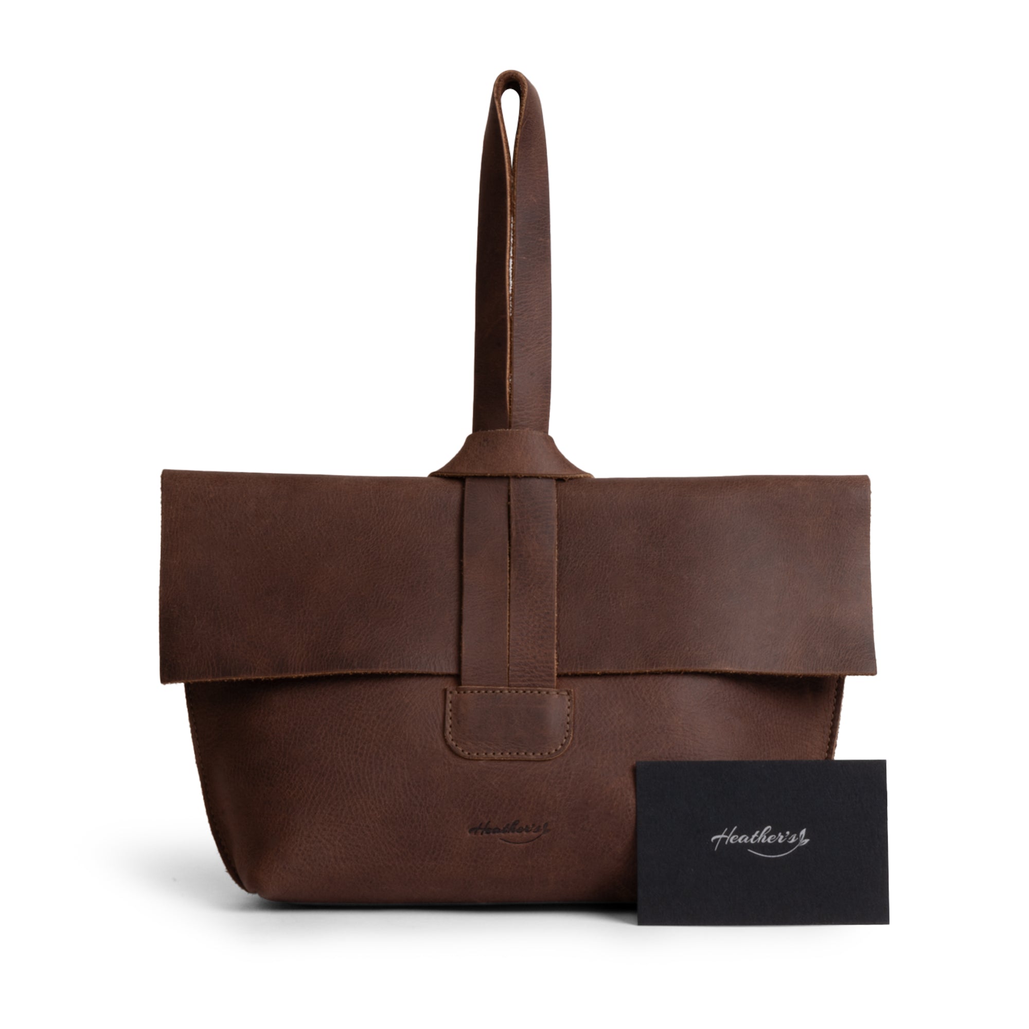 Women's Clutch Bag by Heather's, complete with a tag for authenticity and quality assurance. Crafted from Full Grain Leather in small batches, showcasing the artisan craftsmanship from La Antigua Guatemala, perfect for makeup and travel essentials.