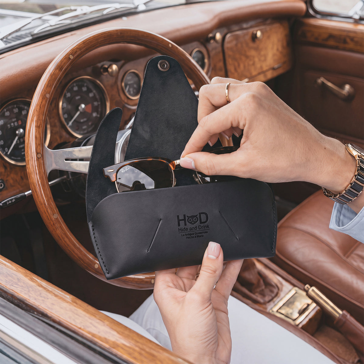 Side view of the black Foldable Sunglass Case by Hide & Drink, showcasing its foldable functionality. Crafted from Full Grain Leather, this case is a proud representation of small batch production and handmade artistry.