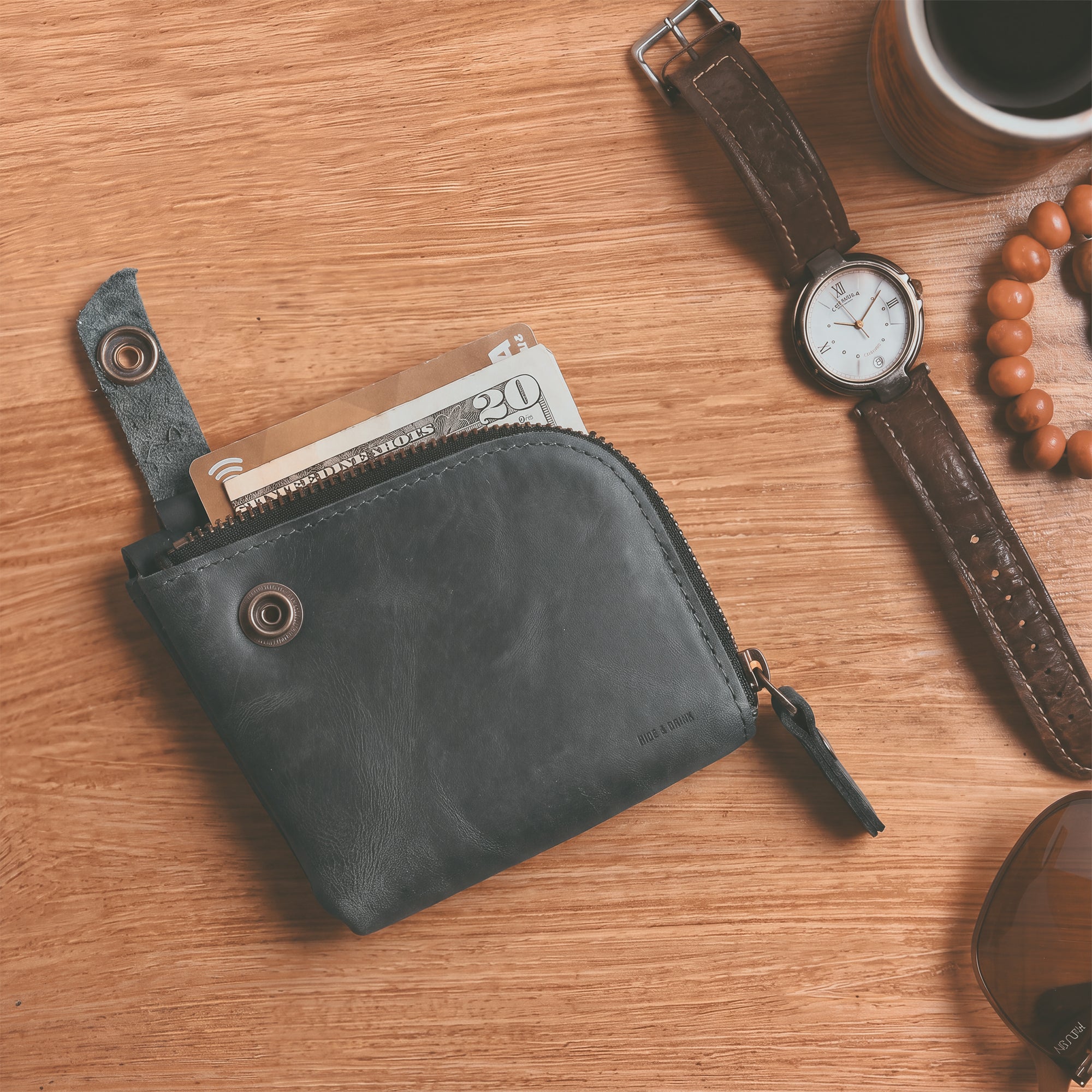 Side view of the blue Lion's Mane Zippered Wallet by Hide & Drink, showcasing its sleek design. Ideal for those looking for a stylish and durable means of organizing their essentials.