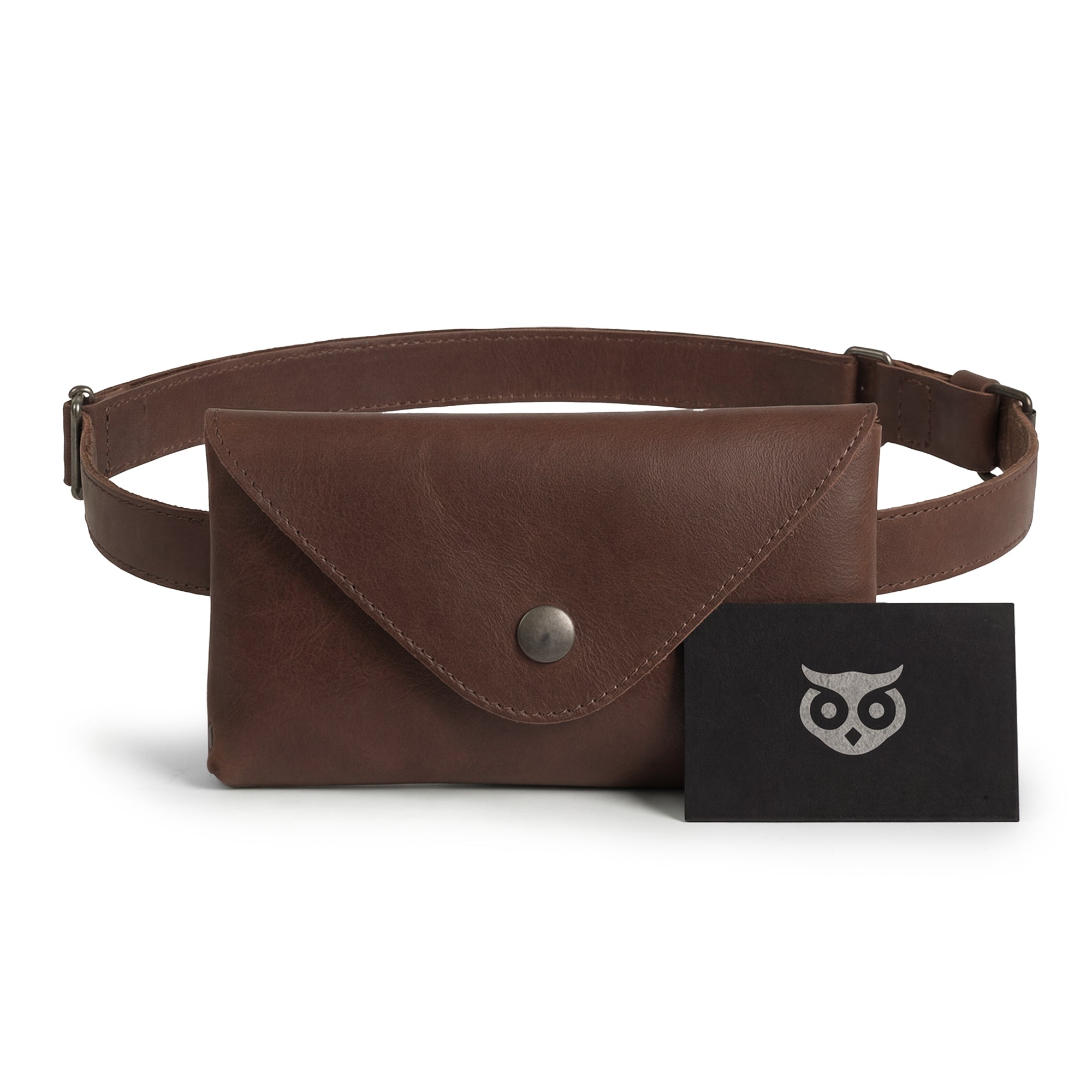 Hide & Drink's Fancy Fanny Pack with tags, showcasing its artisan quality. Crafted from full grain leather, this vintage purse is the ideal waist pouch for easy travel for digital nomads. Each piece is hand cut and sewn, made in small batches in La Antigua Guatemala.