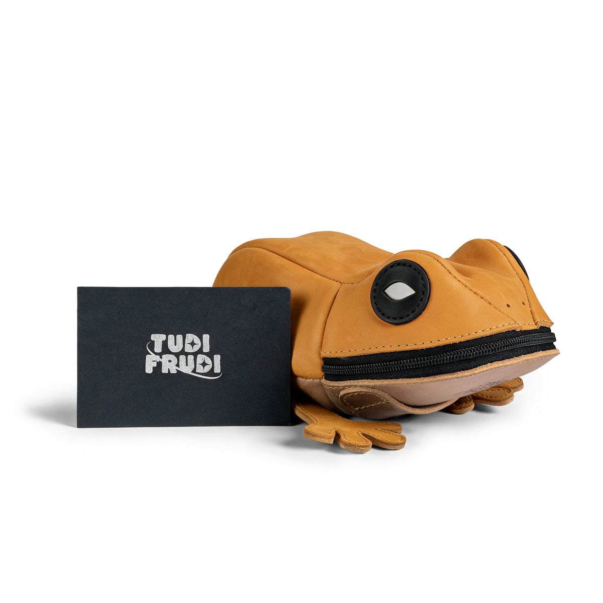 Tudi Frudi Frog Pouch shown beside branded packaging, highlighting its compact frog design and zippered opening; a Frog-Shaped Pouch, Cable Organizer, Small Accessory Case, Zippered Cash Holder Wallet for Coins, and Change Purse suitable for Pouches for Men and Women. This Full Grain Leather pouch reflects StockyardX Small Batch Production and is Hand Cut, Hand Sewn, Fire Branded, Artisan, and Handmade in La Antigua Guatemala & Oaxaca Mexico.
