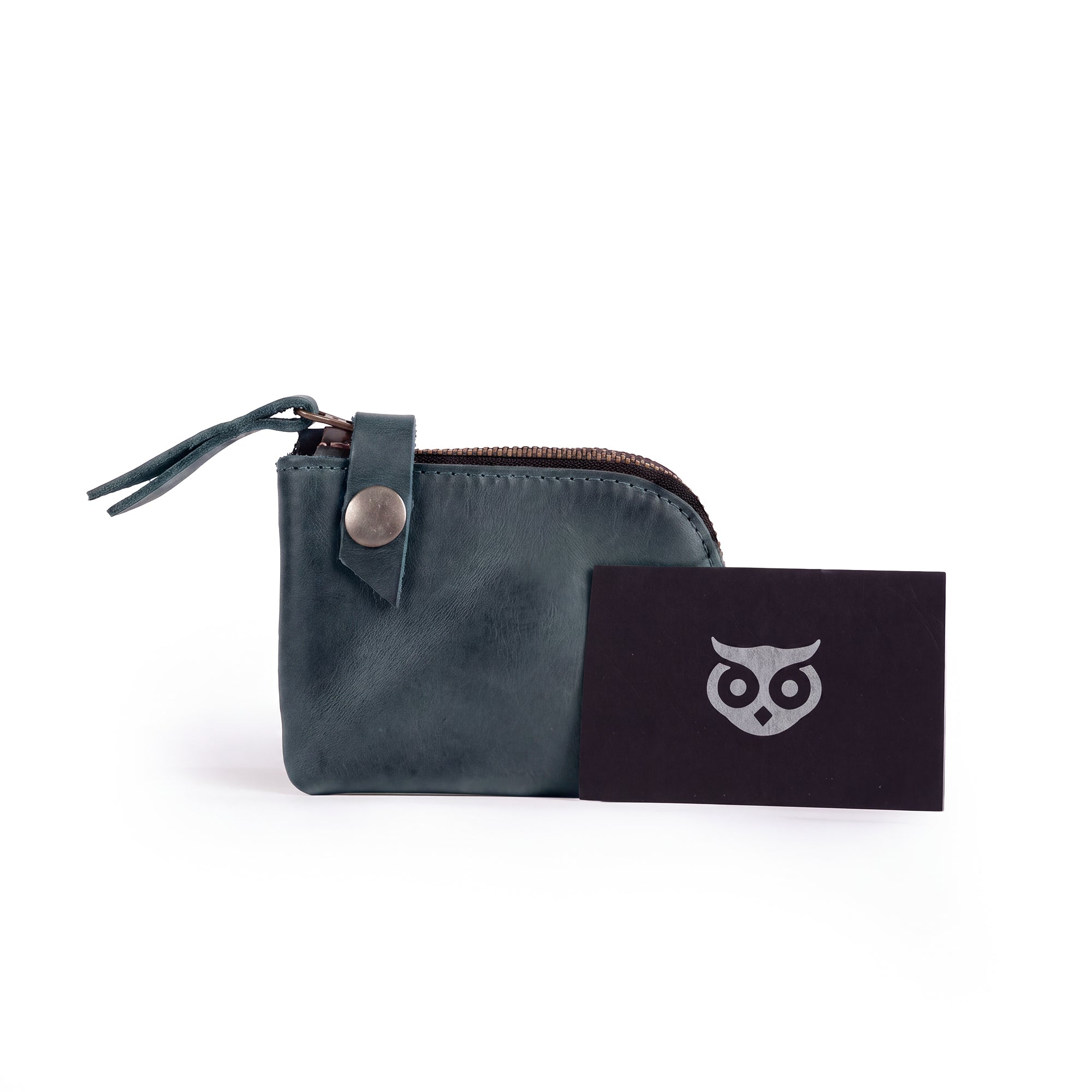 Lion's Mane Zippered Wallet by Hide & Drink, featuring a card and a paper tag showcasing its handmade origin. A stylish piece that makes for a perfect gift or travel essential.