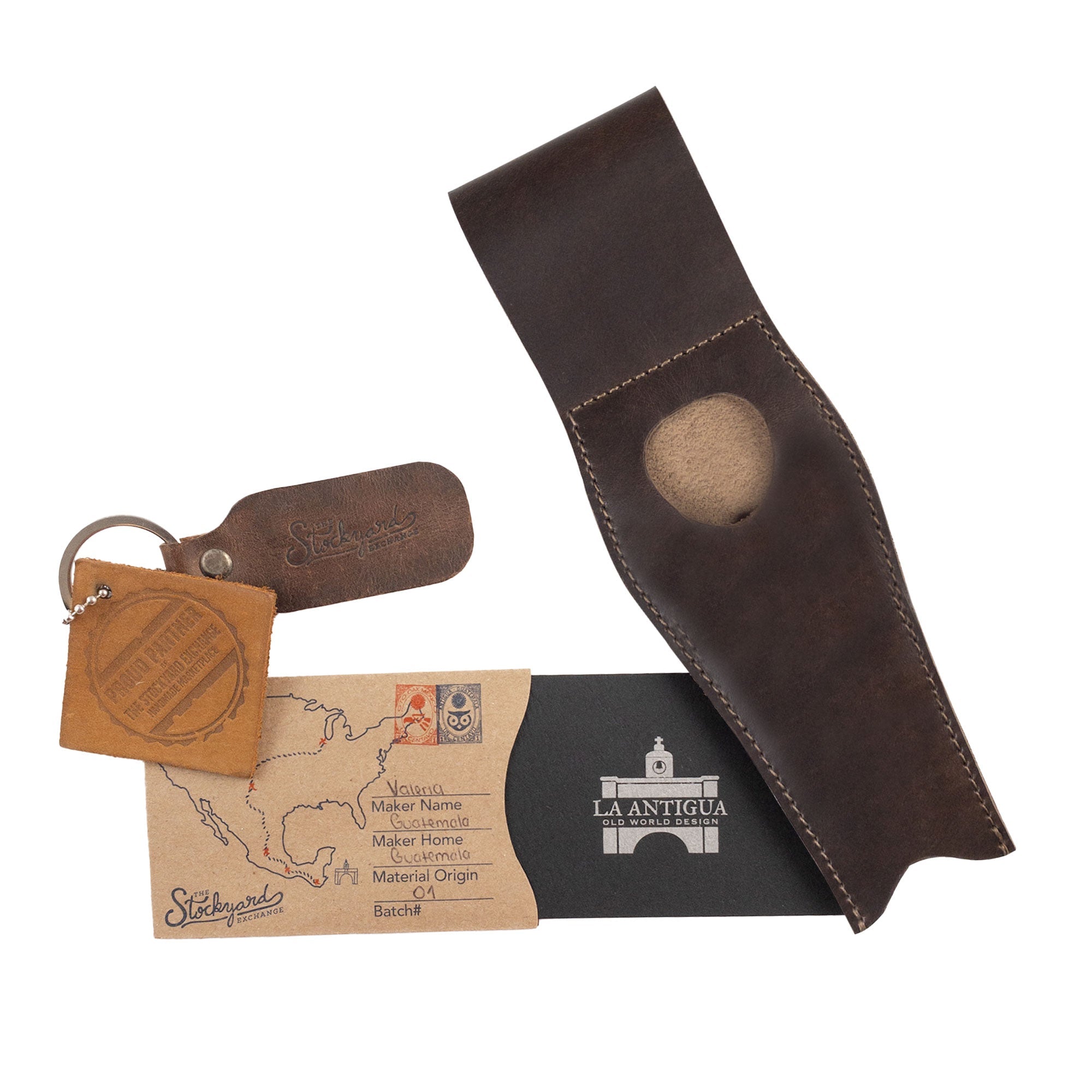 The La Antigua Pipe Case displayed with a keychain and informational tag, demonstrating its artisan quality. This rustic pipe holder with a belt loop is crafted from full grain leather, a perfect waist case serving as a long-lasting travel accessory.