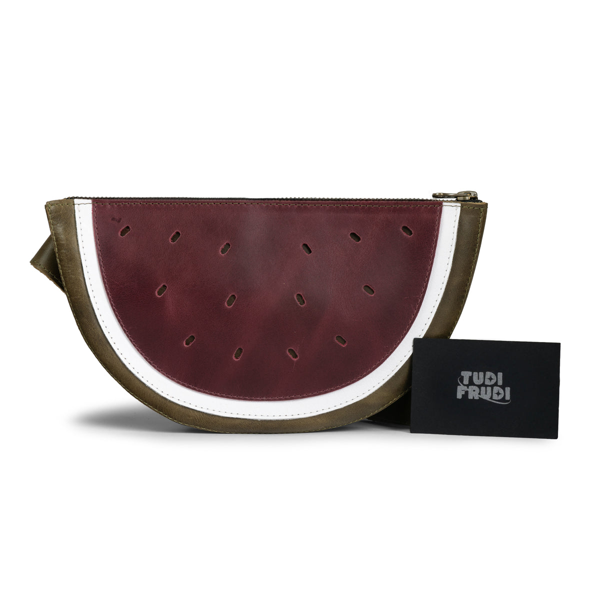 Tudi Frudi Watermelon Crossbody displayed with its branded pouch, a Full Grain Leather Watermelon Crossbody Bag with Adjustable Shoulder Strap, Messenger Bag, Shoulder Bag, Zippered Sling Bags, Travel Backpack, Purses for Men and Women, Satchel, Full Grain Leather, StockyardX, Small Batch Production, Hand Cut, Hand Sewn, Fire Branded, Artisan, Handmade in La Antigua Guatemala & Oaxaca Mexico.