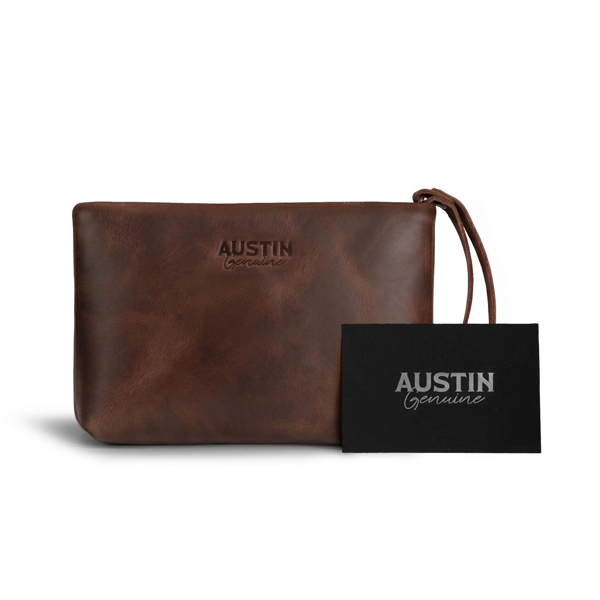 Austin Genuine The Seaholm Makeup Bag displayed with branded packaging, featuring a brown Full Grain Leather body and wrist strap; StockyardX Small Batch Production, Hand Cut, Hand Sewn, Fire Branded, Artisan, Handmade in La Antigua Guatemala & Oaxaca Mexico.