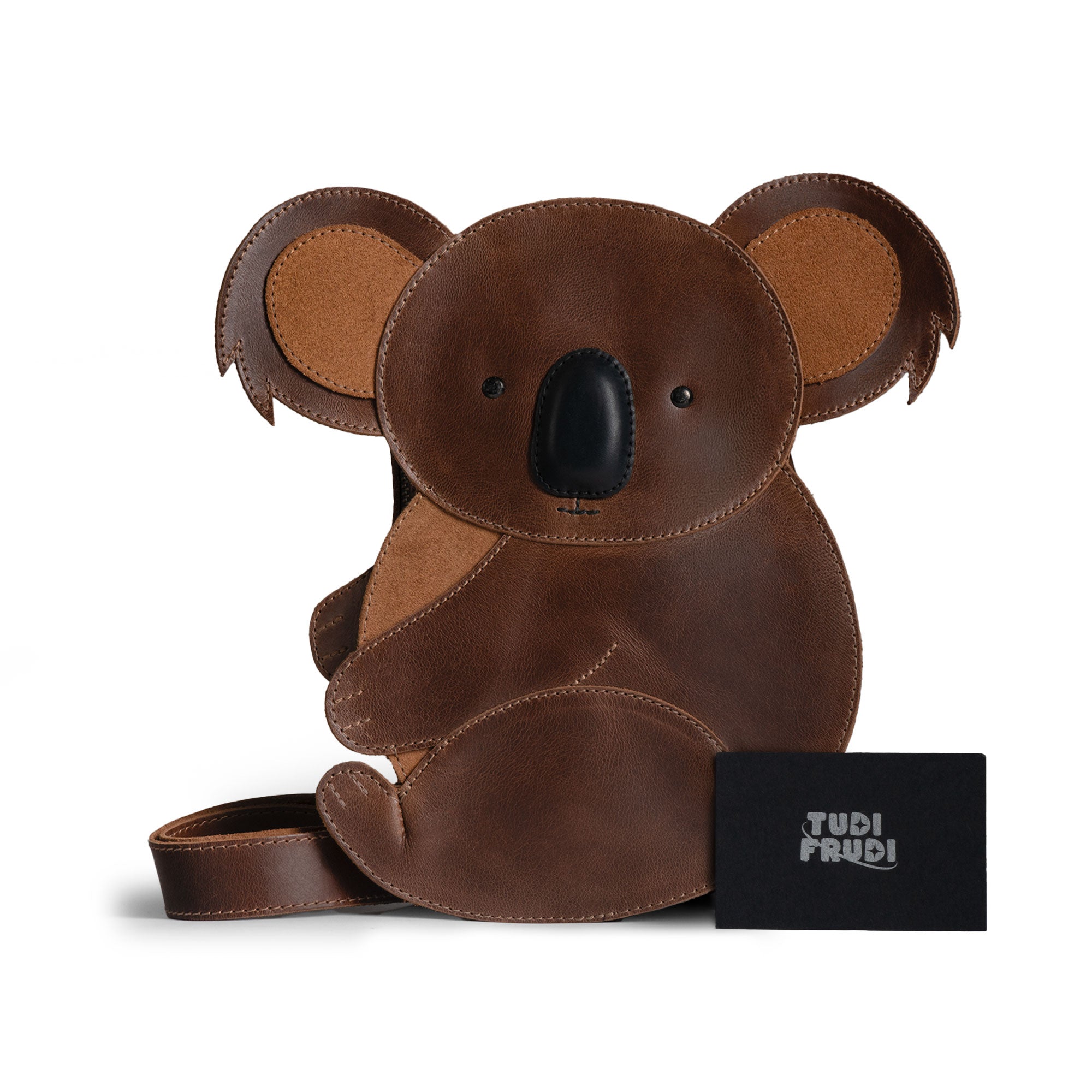Tudi Frudi Leather Koala Crossbody Bag displayed with care card, underscoring its artisanal craftsmanship. This unique bag is made of full grain leather, serving as a messenger bag or purse for both men and women, handcrafted in La Antigua Guatemala and Oaxaca Mexico.