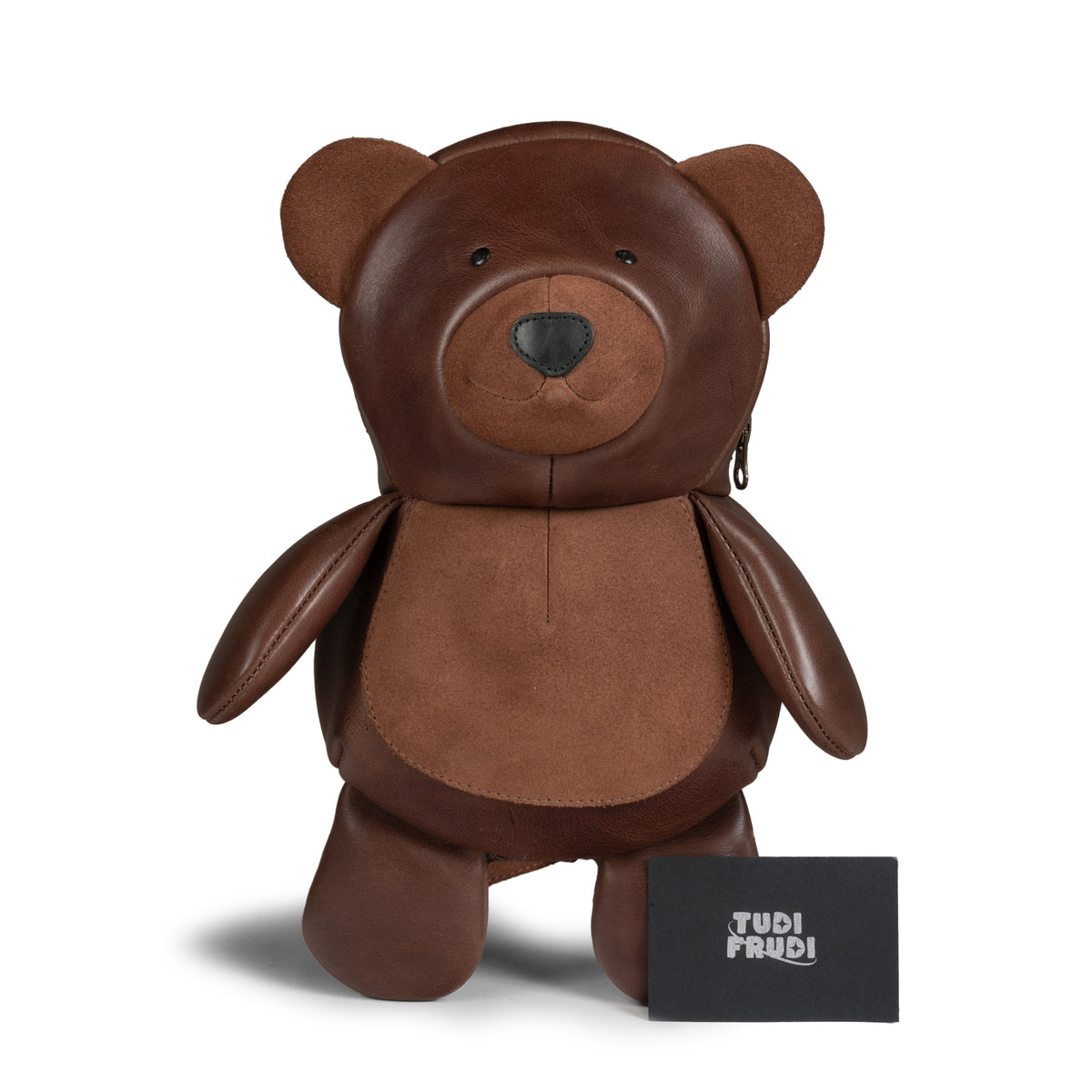 Front product view of the Tudi Frudi Leather Teddy Bear Crossbody Bag beside its brand card, showcasing the detailed brown teddy bear design, Adjustable Shoulder Strap, Messenger Bag, Shoulder Bag, Zippered Sling Bags, Travel Backpack, Purses for Men and Women, Satchel style, Full Grain Leather, StockyardX, Small Batch Production, Hand Cut, Hand Sewn, Fire Branded, Artisan, Handmade in La Antigua Guatemala & Oaxaca Mexico.