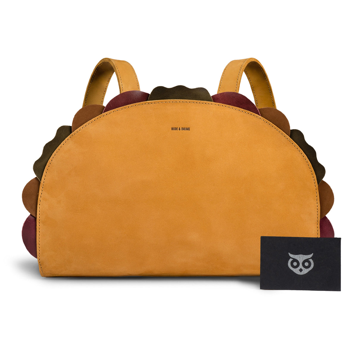 Front view of the Hide & Drink Taco Backpack with artisan brand card, a Taco Backpack and Fashion Zippered Bag with Carry Pack with Adjustable Shoulder Straps, Fun Carryalls style, Casual Daypack design, and Travel Accessory appeal; crafted from Full Grain Leather by StockyardX through Small Batch Production, Hand Cut and Hand Sewn with Fire Branded Artisan details, Handmade in La Antigua Guatemala & Oaxaca Mexico.