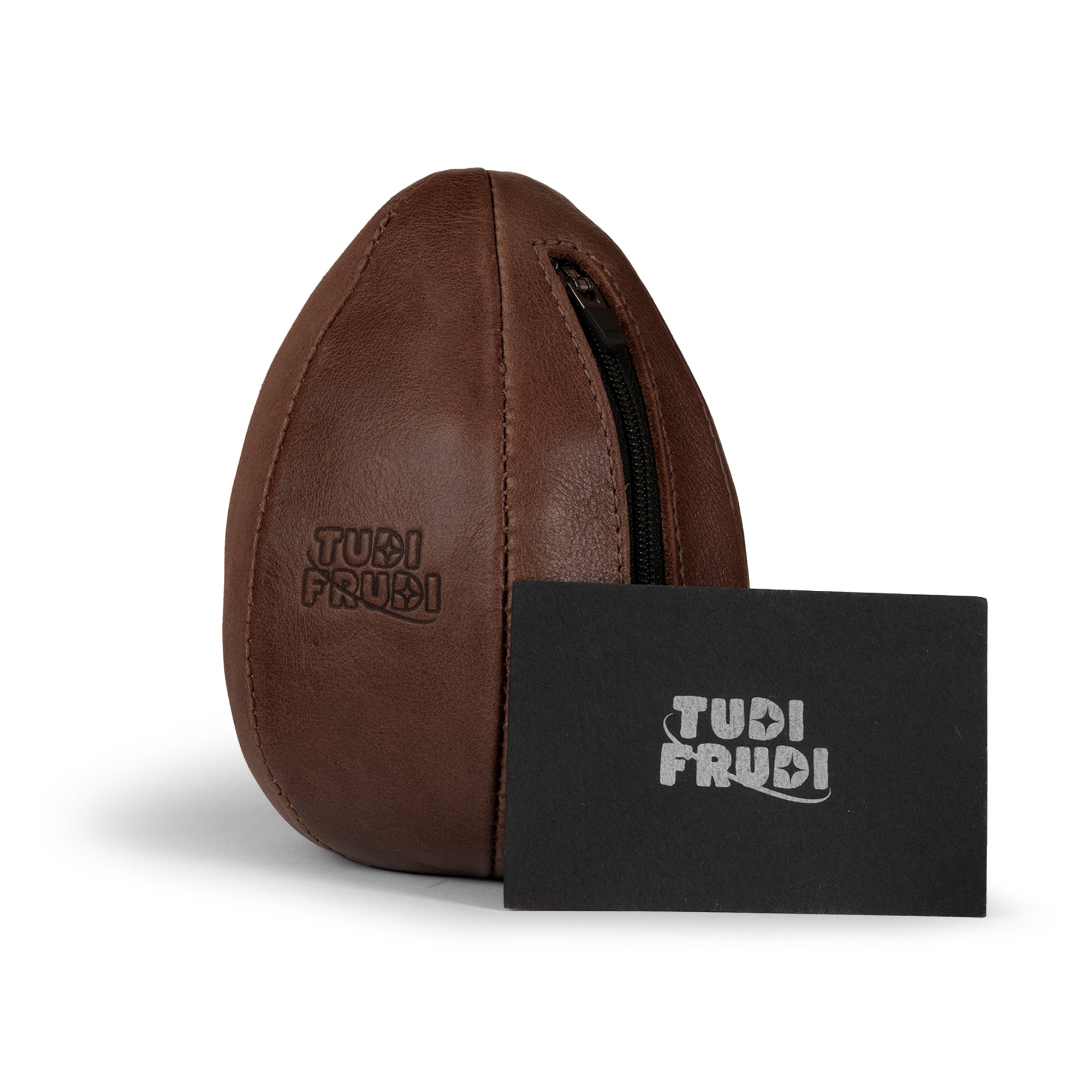 Brown Tudi Frudi Dragon Egg Pouch displayed with its branded card, featuring Full Grain Leather, StockyardX Small Batch Production, Hand Cut and Hand Sewn construction, Fire Branded logo, and Artisan quality Handmade in La Antigua Guatemala & Oaxaca Mexico.