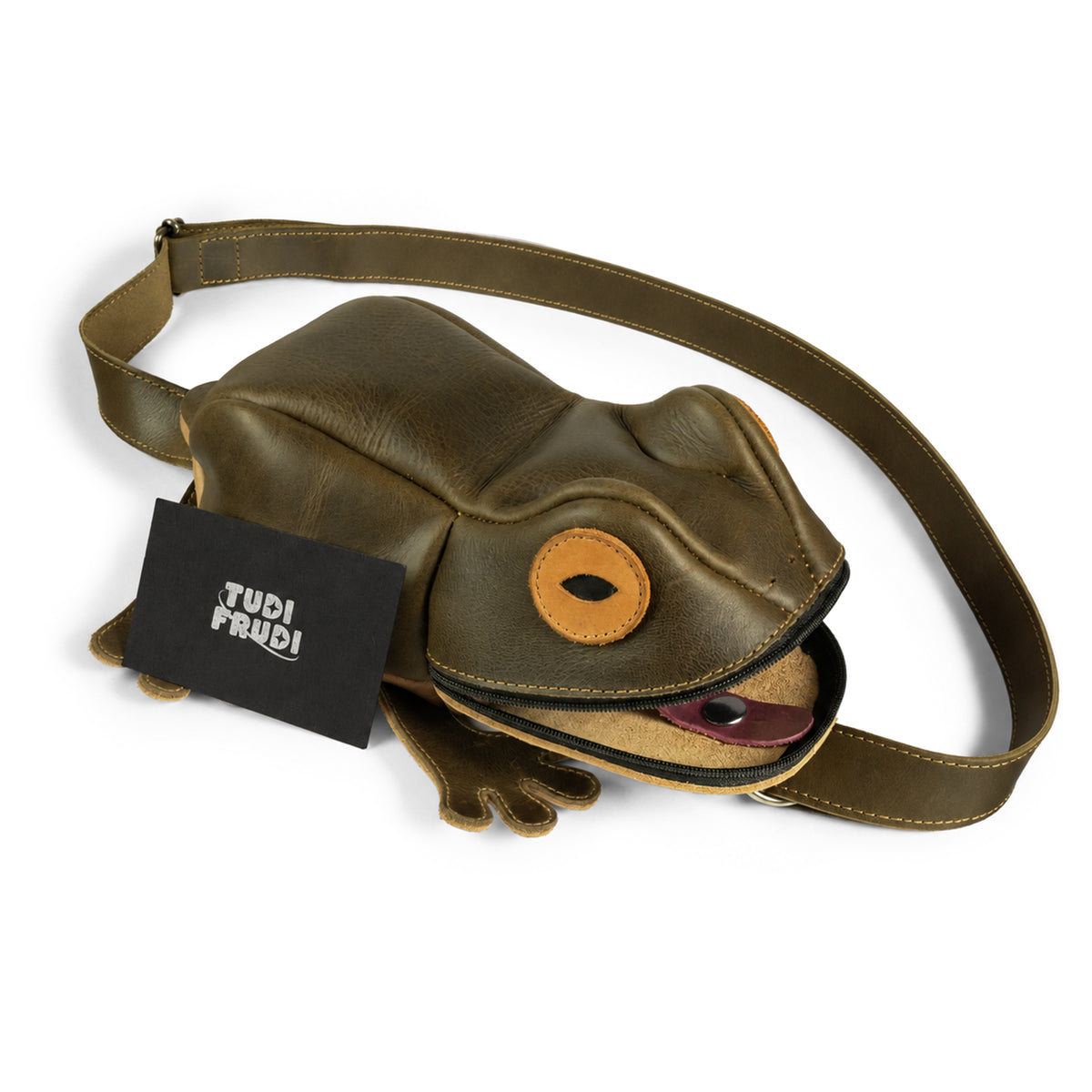 Tudi Frudi Frog Crossbody displayed open with its frog-shaped design, branded card, and adjustable strap; a handmade Full Grain Leather Frog Crossbody Bag with Adjustable Shoulder Strap, Messenger Bag, Shoulder Bag, Zippered Sling Bags, Travel Backpack, Purses for Men and Women, and Satchel by StockyardX, made through Small Batch Production, Hand Cut, Hand Sewn, Fire Branded, Artisan craftsmanship, Handmade in La Antigua Guatemala & Oaxaca Mexico.