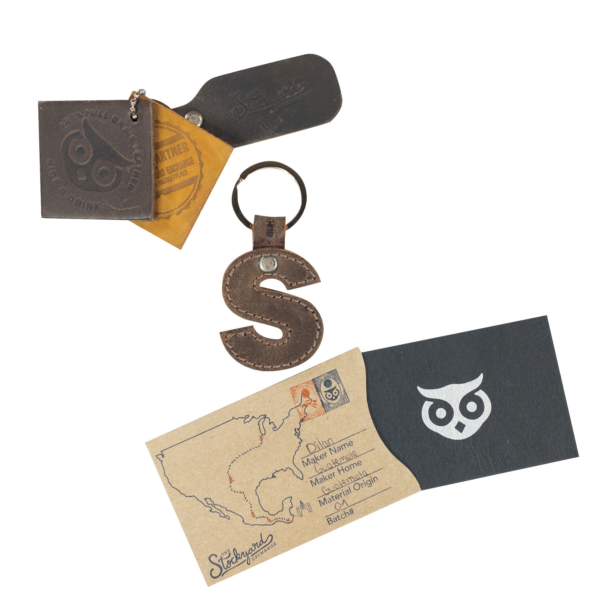 Assorted packaging alongside the letter S Alphabet Letter Keychain by Hide & Drink. This handmade piece of thick Full Grain Leather speaks to the artisan production methods in La Antigua Guatemala.