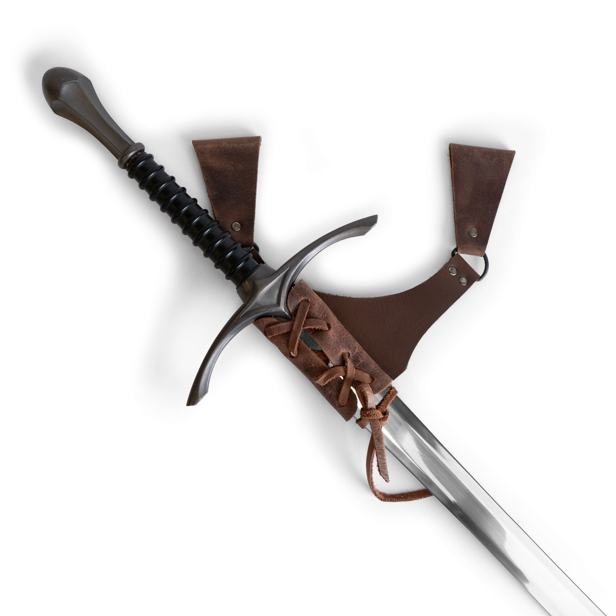 A stunning Dangling Sword Holder by Hide & Play featuring a sword secured in a full grain leather harness, ideal for fantasy cosplay or historical costume accessory. This handmade piece showcases artisan craftsmanship, fire branded details, and is produced in small batches in La Antigua Guatemala and Oaxaca Mexico.