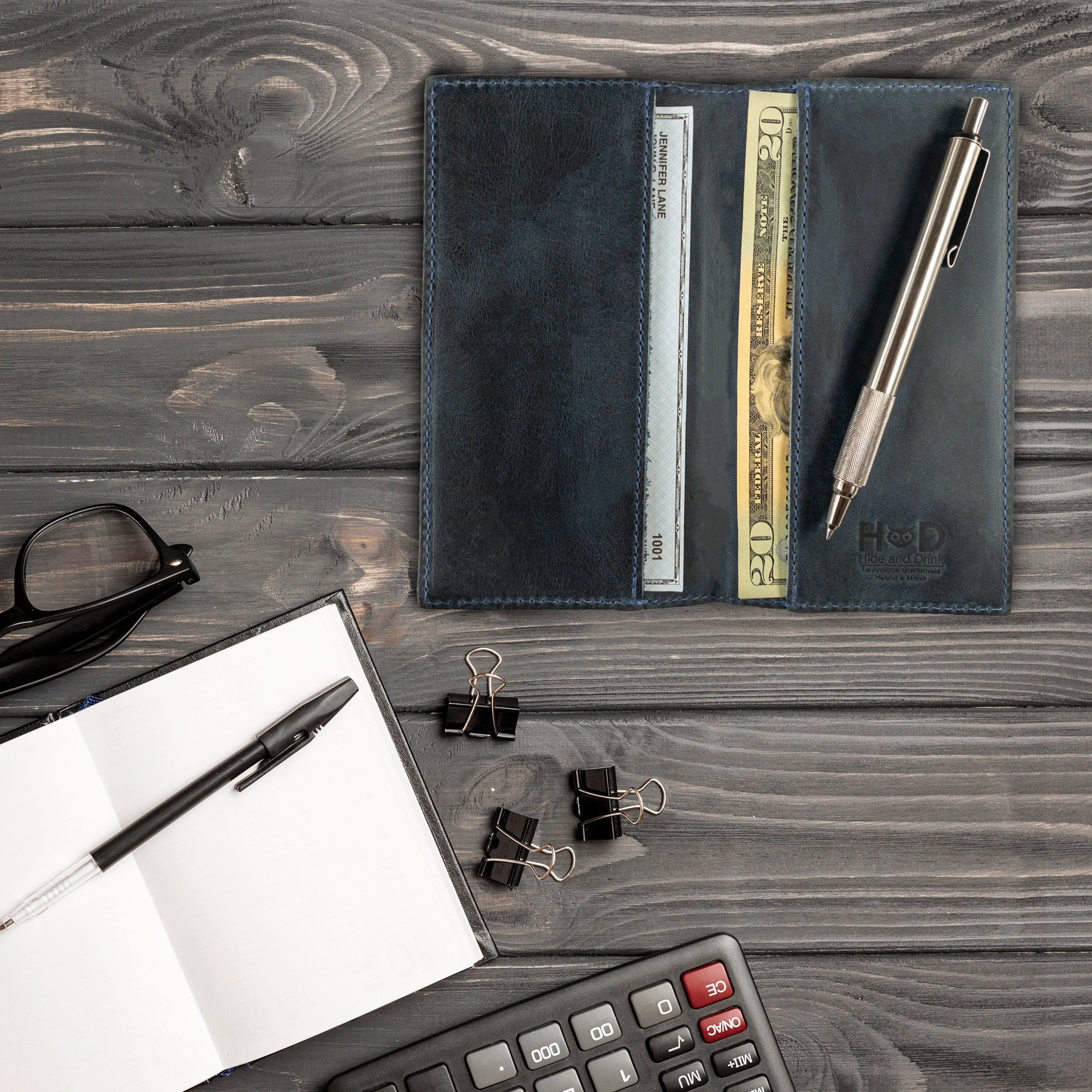 Checkbook Leather Cover by Hide & Drink in dark brown, designed to function as a minimalist organizer for standard checkbooks. This artisan item is handmade from full grain leather, reflecting craftsmanship from La Antigua Guatemala and Oaxaca Mexico, showcasing small batch production.