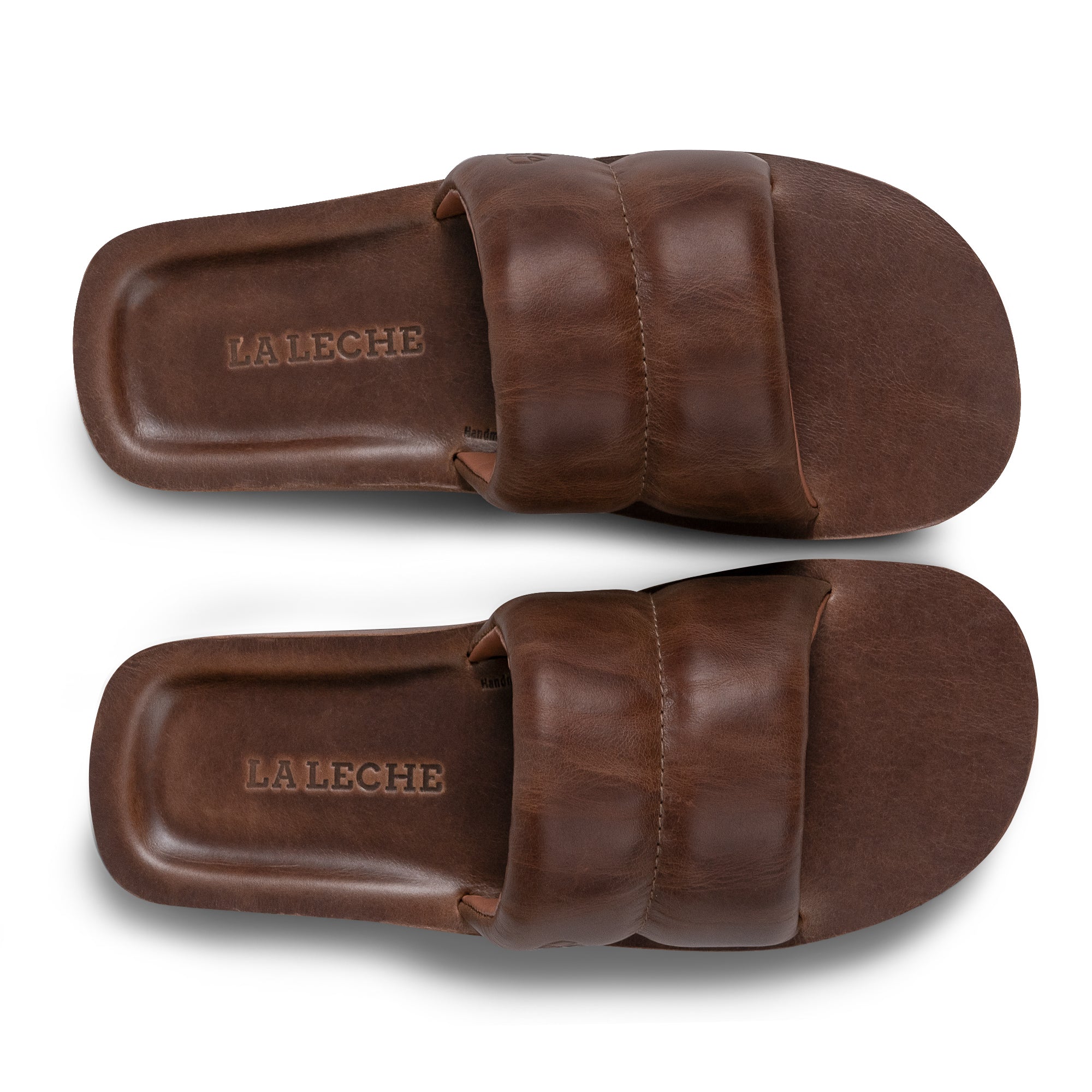 Top down view of The Bayside Leather Slide by StockyardX, highlighting the refined leather finish. This bayside sandal, crafted from full grain leather, promises exceptional comfort. Handcrafted in La Antigua Guatemala & Oaxaca Mexico, it exemplifies artisanal quality.