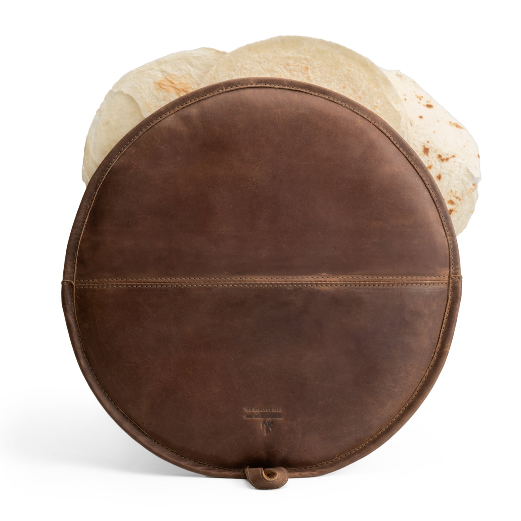 An elegant Tortilla Warmer from Cast Leather Co., showcasing a full grain leather pouch with tortillas peeking out, perfect for Taco Tuesday. This Tortilla Warmer Pouch is a Fabric Tortilla Heater Pouch, crafted through small batch production, hand cut, and hand sewn, fire branded and artisan made in La Antigua Guatemala & Oaxaca Mexico.