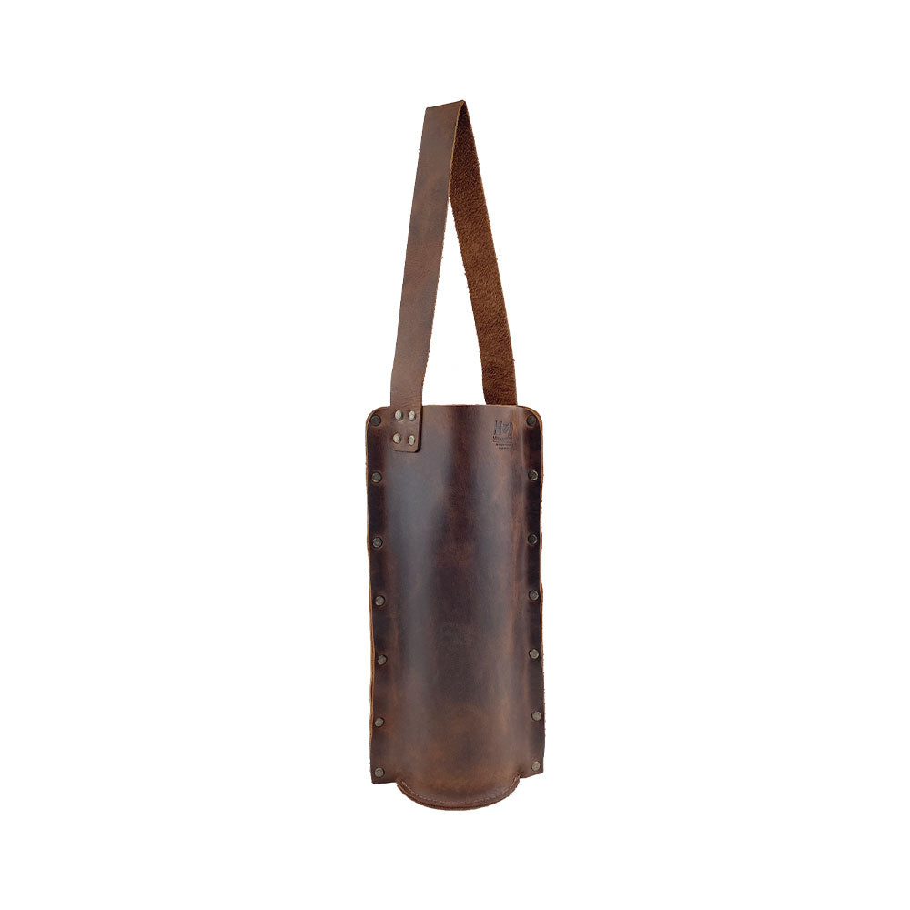 Rustic Wine Carrier For Standard 750ml Bordeaux Bottle by Hide & Drink, highlighting the elegant design of this Single Wine Carrier made from Full Grain Leather. A true artisan product featuring small batch production, hand cutting, and hand sewing, fire branded, and crafted in La Antigua Guatemala & Oaxaca Mexico.