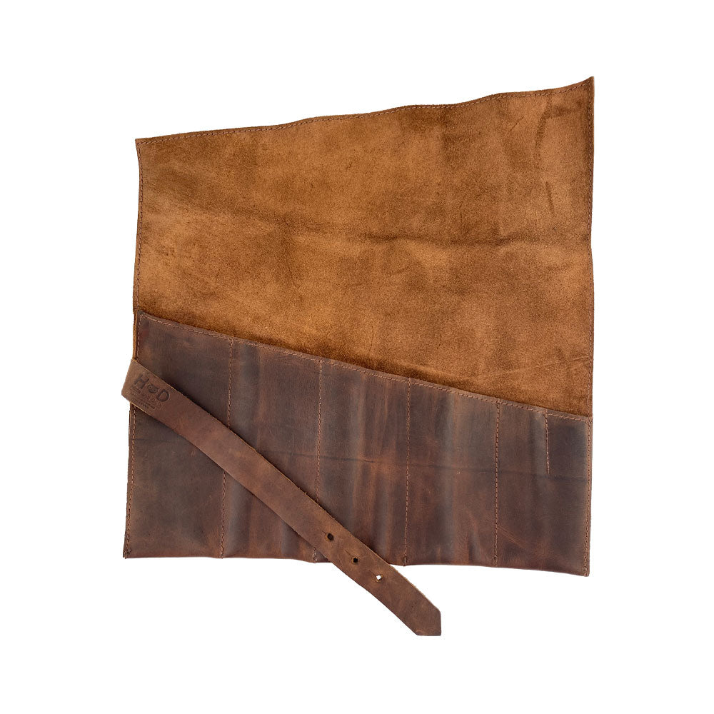 A Large Tool Roll from Hide & Drink showcasing a rich suede design. This Portable Carry-On Pouch offers 6 slots, making it perfect for organizing woodworking tools. Made with Waxed Canvas & Full Grain Leather variations, this artisan product features hand-cut and hand-sewn details, ensuring quality craftsmanship from StockyardX, Handmade in La Antigua Guatemala & Oaxaca Mexico.