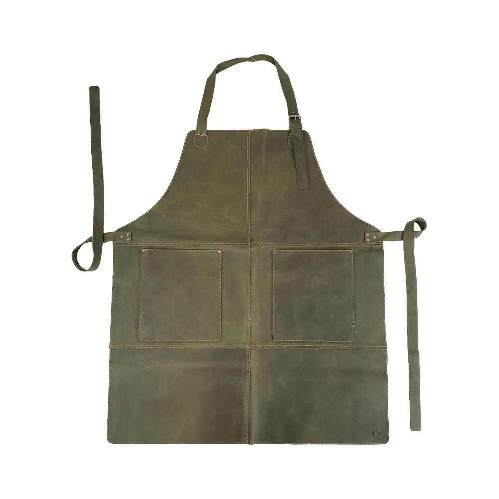 Hide & Drink Leather Apron in a unique rich green tone, featuring large pockets and adjustable straps, handcrafted from full grain leather, ideal for various tasks and uses.