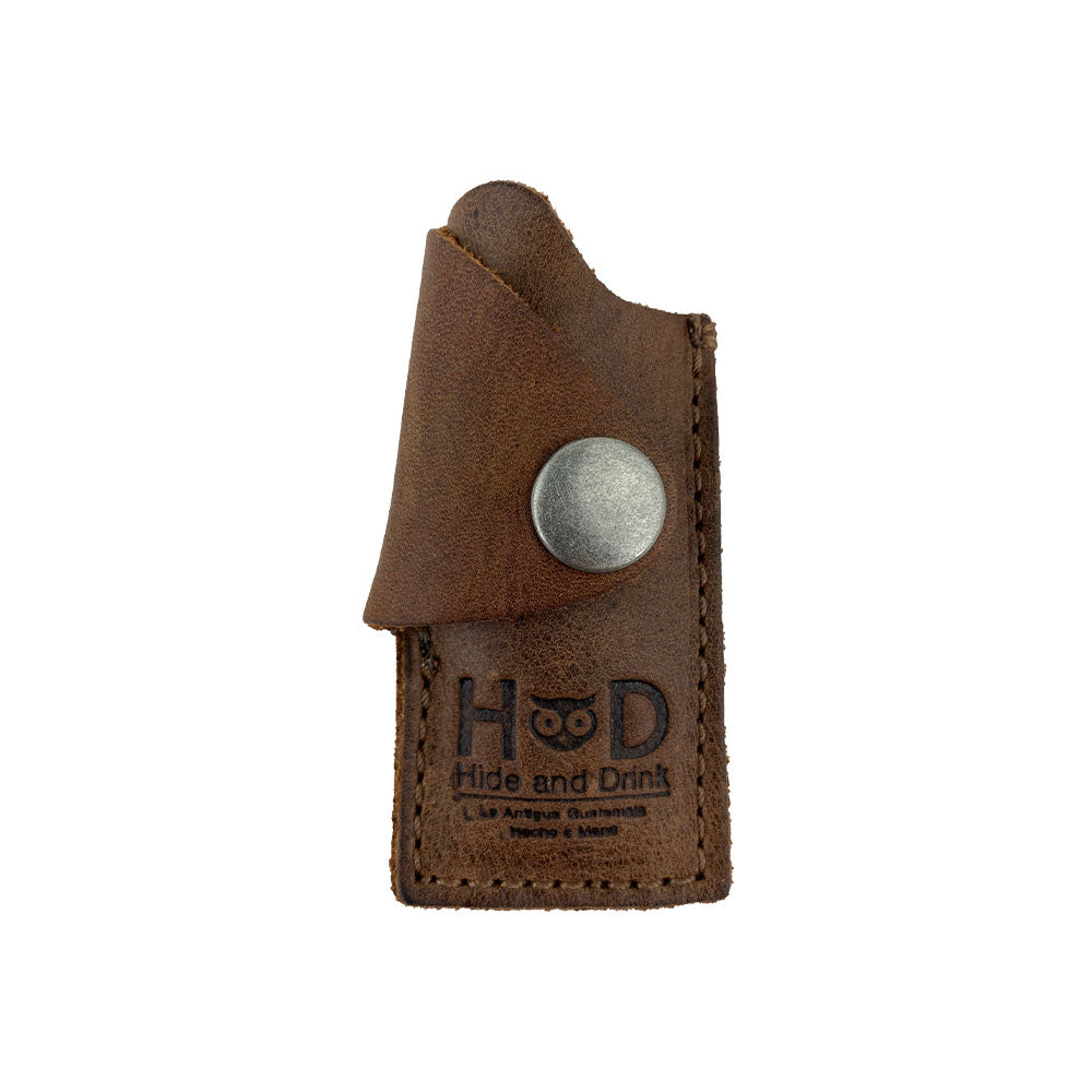 Hide & Drink Lighter Protective Case showcasing a rustic full grain leather design, perfect for keeping your lighter safe and stylish. Handmade in La Antigua Guatemala & Oaxaca Mexico, featuring artisan craftsmanship with hand cut and hand sewn details. Includes tags: Lighter Protective Case, Full Grain Leather, StockyardX, Small Batch Production, Fire Branded.