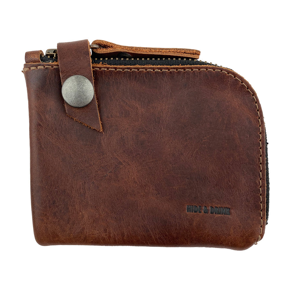Lion's Mane Zippered Wallet by Hide & Drink, a compact zippered wallet made of full grain leather, ideal for storing cards and cash. Perfect travel essentials and a stylish mini pouch organizer, crafted with attention to detail in La Antigua Guatemala.