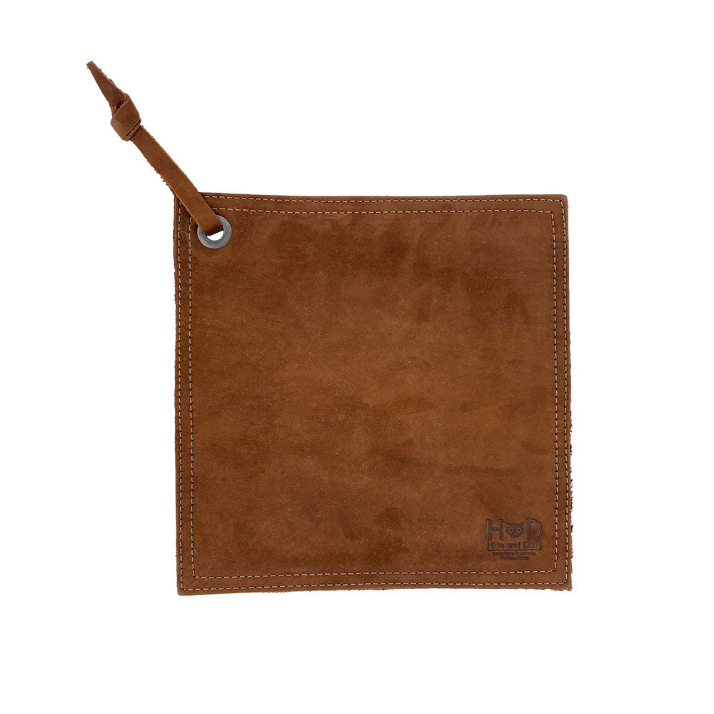 Hide & Drink Pot Pad made of premium suede featuring a rustic leather design. This handmade pot holder is double-layered and crafted with full grain leather, making it a durable choice for hot pots. Artisan crafted in La Antigua Guatemala & Oaxaca Mexico.