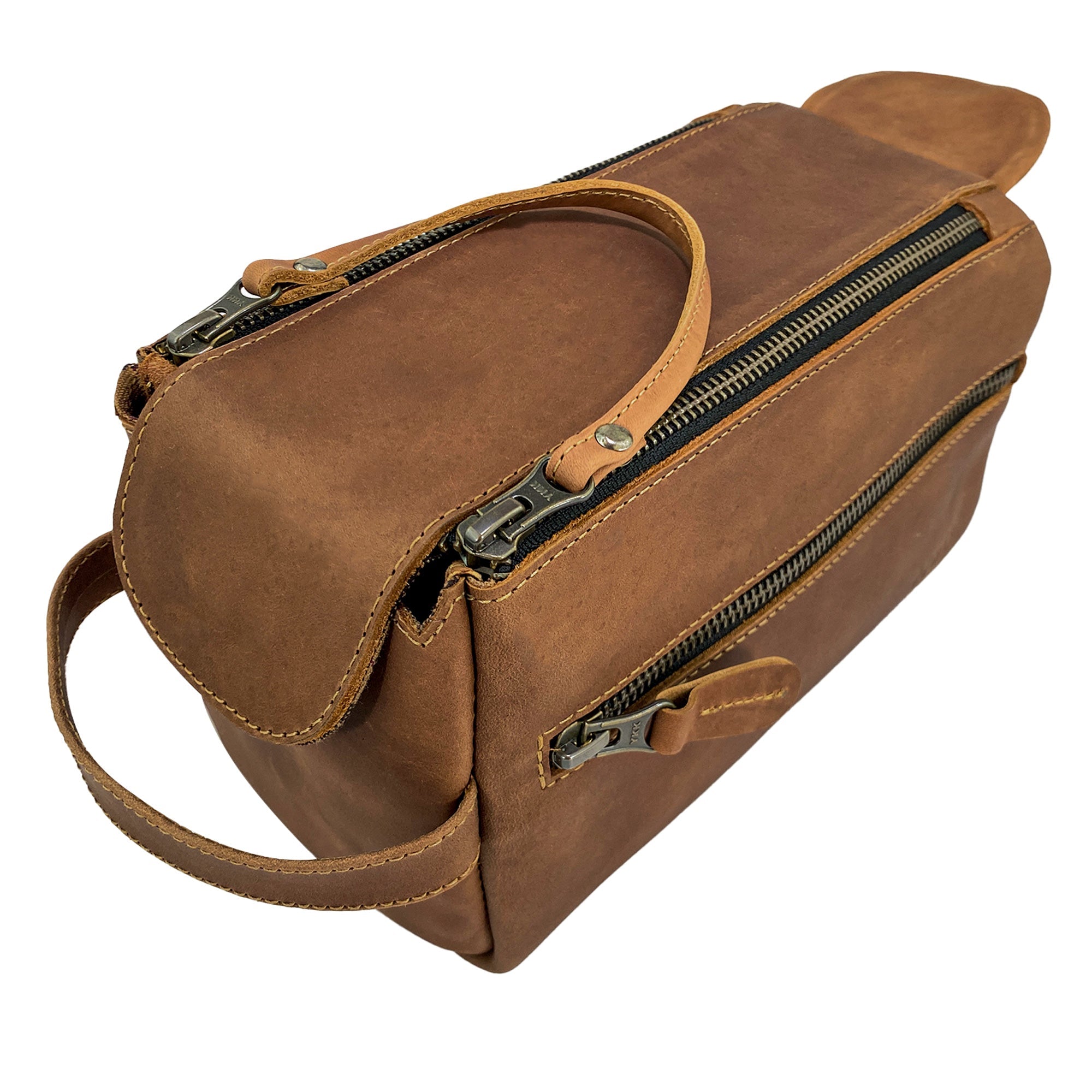 Hide & Drink's Toiletry Bag care tag displayed with leather finish. This Full Grain Leather Toiletry Bag serves as an excellent Hand Bag or Dopp Kit Organizer, blending style and function. StockyardX, Handmade, S.