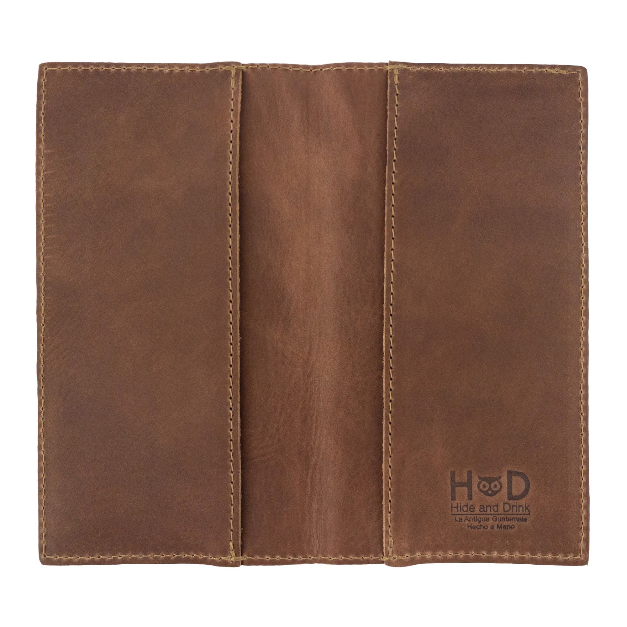 Checkbook Leather Cover by Hide & Drink in a rich brown shade, designed to function as a minimalist organizer for standard checkbooks. This artisan product, handmade from full grain leather, highlights craftsmanship from La Antigua Guatemala and Oaxaca Mexico, emphasizing small batch production.