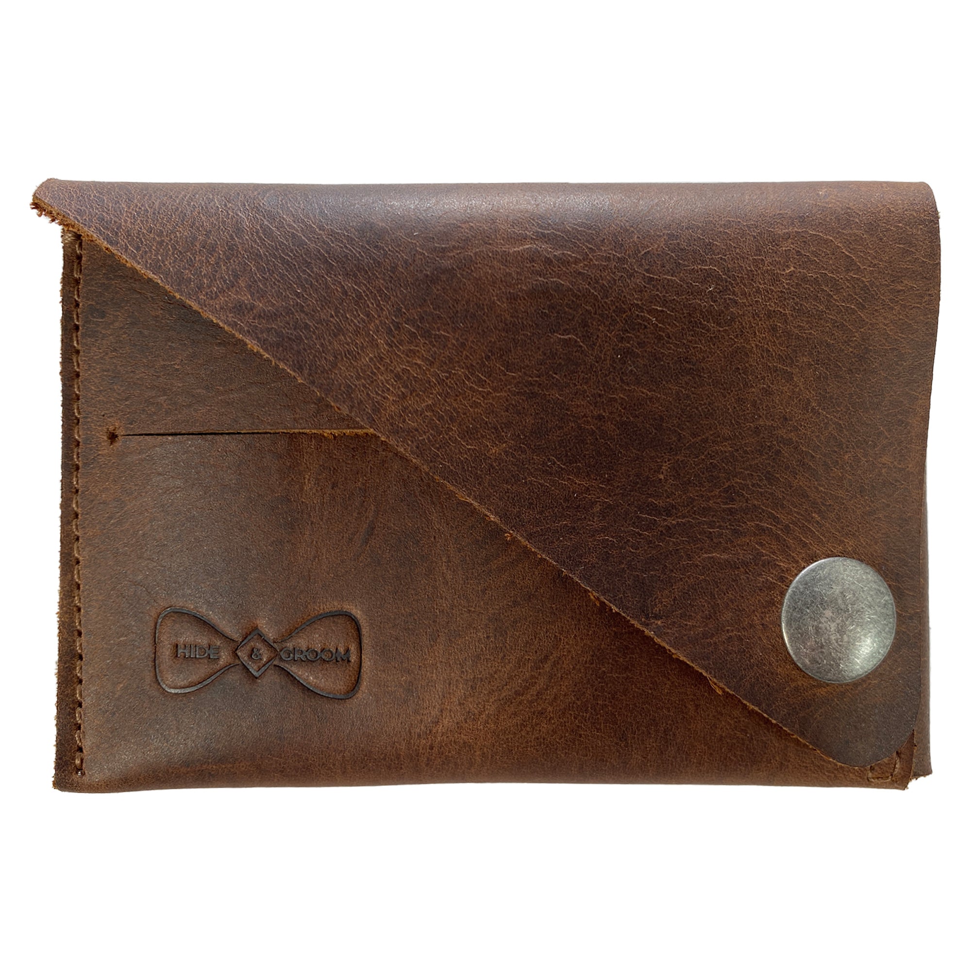 Hide & Groom Minimalist Wallet crafted from full grain leather, showcasing a stylish and compact design ideal for holding business cards and cash. This handmade wallet is part of a small batch production process, emphasizing artisanal quality from La Antigua Guatemala. Minimalist Wallet - Business Card & Money Holder, Stylish Compact Money Organizer, Full Grain Leather, StockyardX, Small Batch Production, Hand Cut, Hand Sewn, Fire Branded, Artisan, Handmade in La Antigua Guatemala & Oaxaca Mexico.