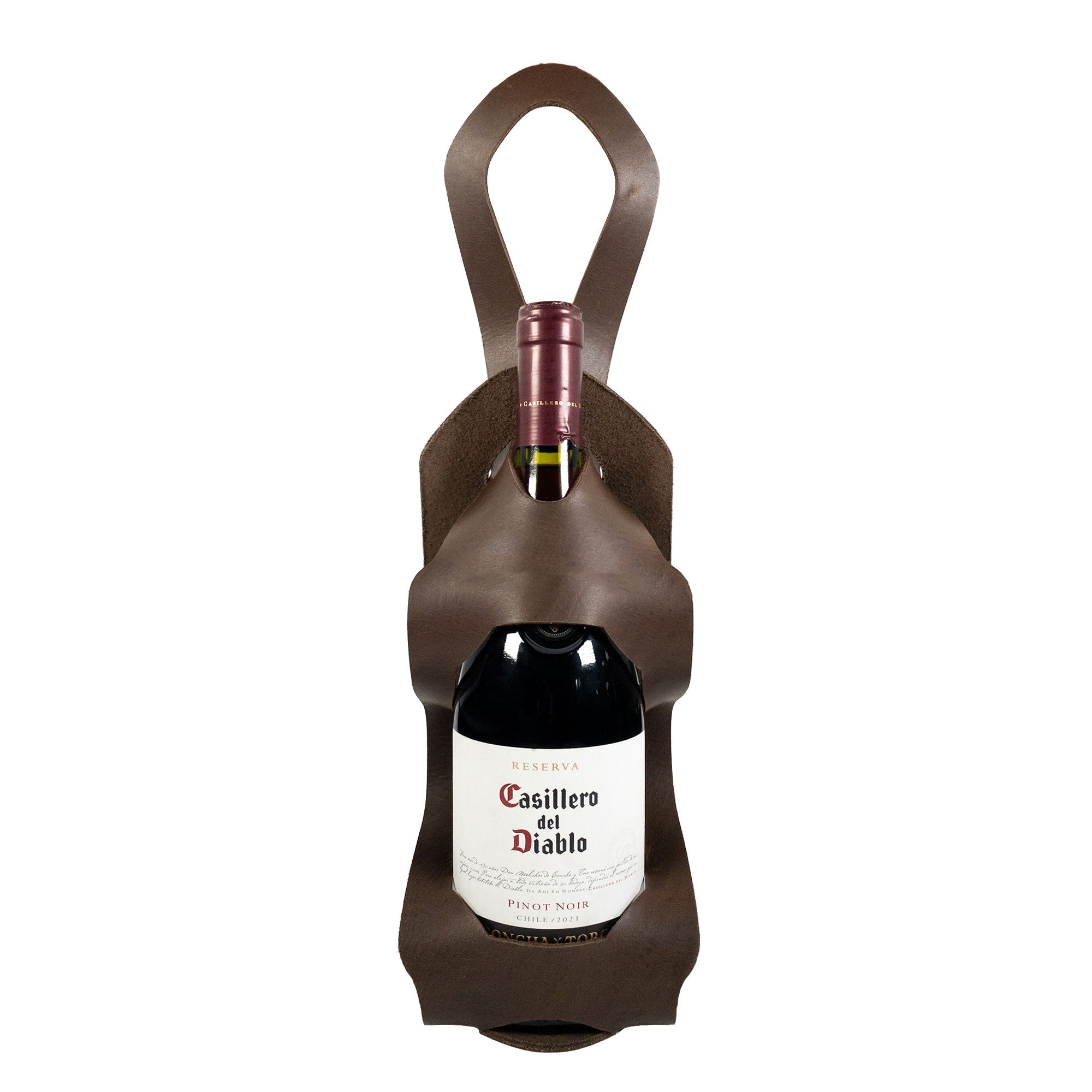 The Unibody Bike Wine Carrier by Hide & Drink, made from Full Grain Leather, elegantly holds a wine bottle. This artisan product highlights small batch production and is hand cut, hand sewn, and fire branded, embodying craftsmanship from La Antigua Guatemala & Oaxaca Mexico.