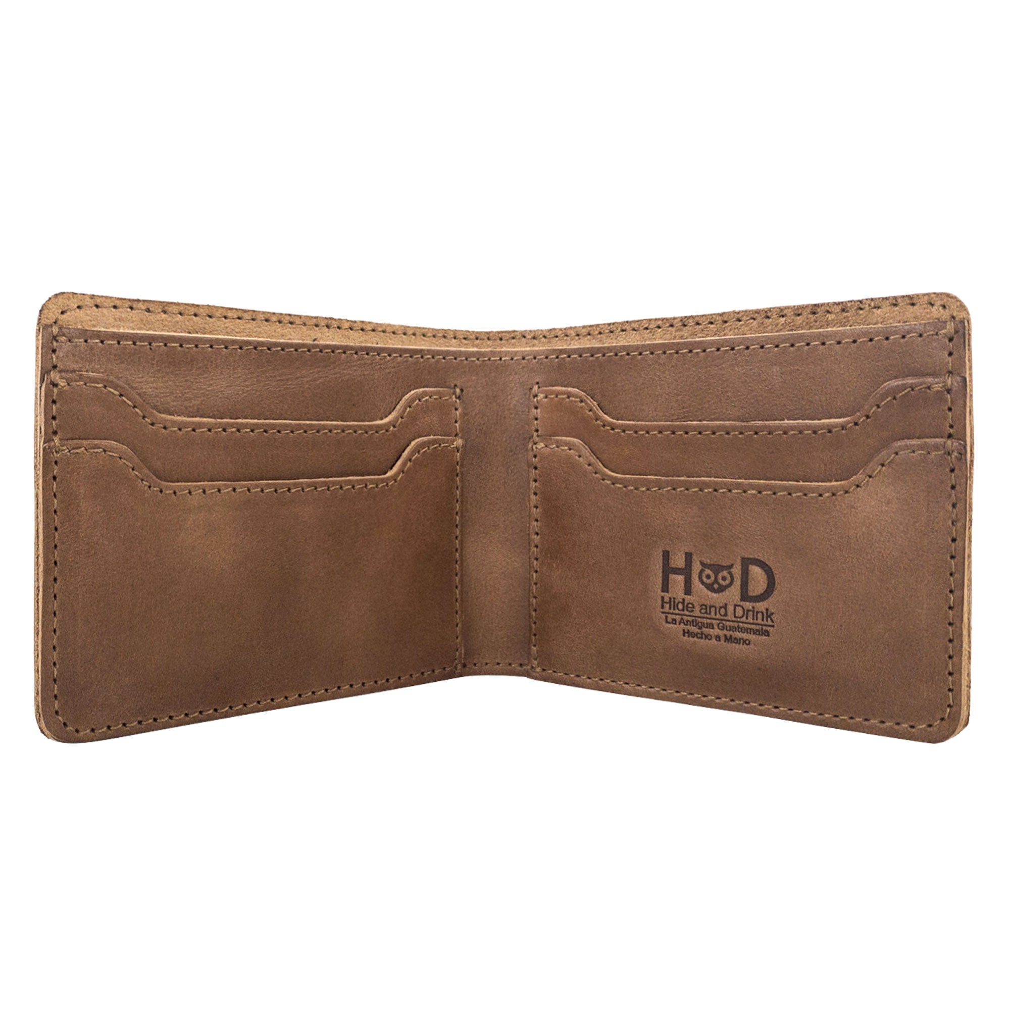 Open dark brown Classic Wallet from Hide & Drink showcasing card slots and cash. This Classic Bifold Wallet, made from Full Grain Leather, provides a convenient storage case for identification. A stylish travel accessory, it features artisan craftsmanship and is the result of small batch production, hand cut and sewn in La Antigua Guatemala & Oaxaca Mexico.
