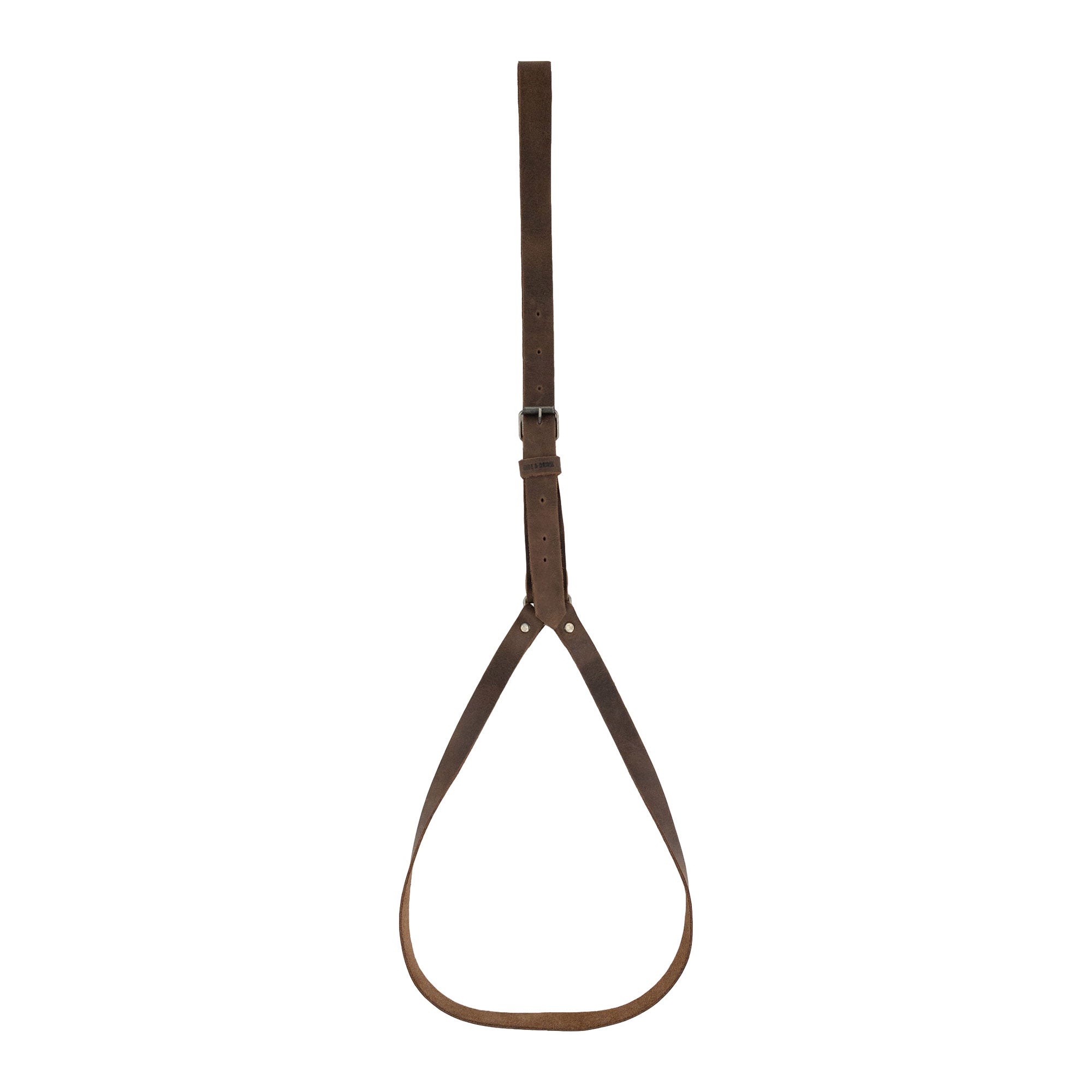 Hat Hanger by Hide & Drink featuring a minimalist design with an adjustable strap for car organization. This travel accessory is handmade in La Antigua Guatemala & Oaxaca Mexico using full grain leather. Ideal for keeping hats organized while on the go, showcasing small batch production and fire branded craftsmanship.