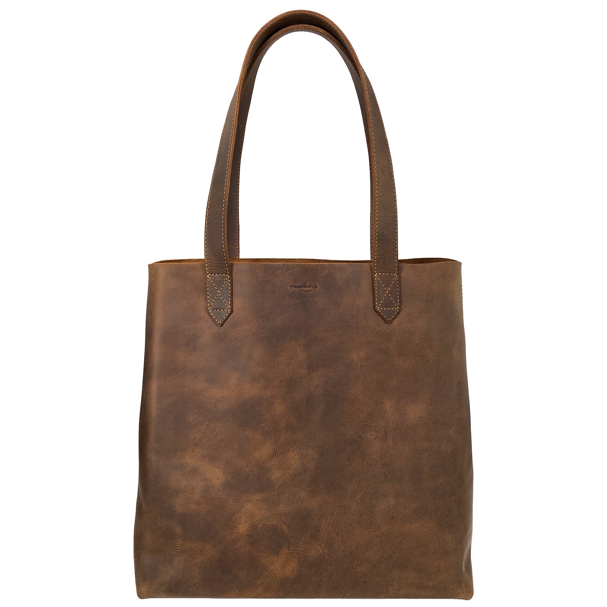 Heather's Classic Tote Bag showcasing elegant full grain leather in a vintage style purse design, perfect for travel and shopping. Features spacious interior, hand cut and sewn in La Antigua Guatemala, embodying artisan craftsmanship.