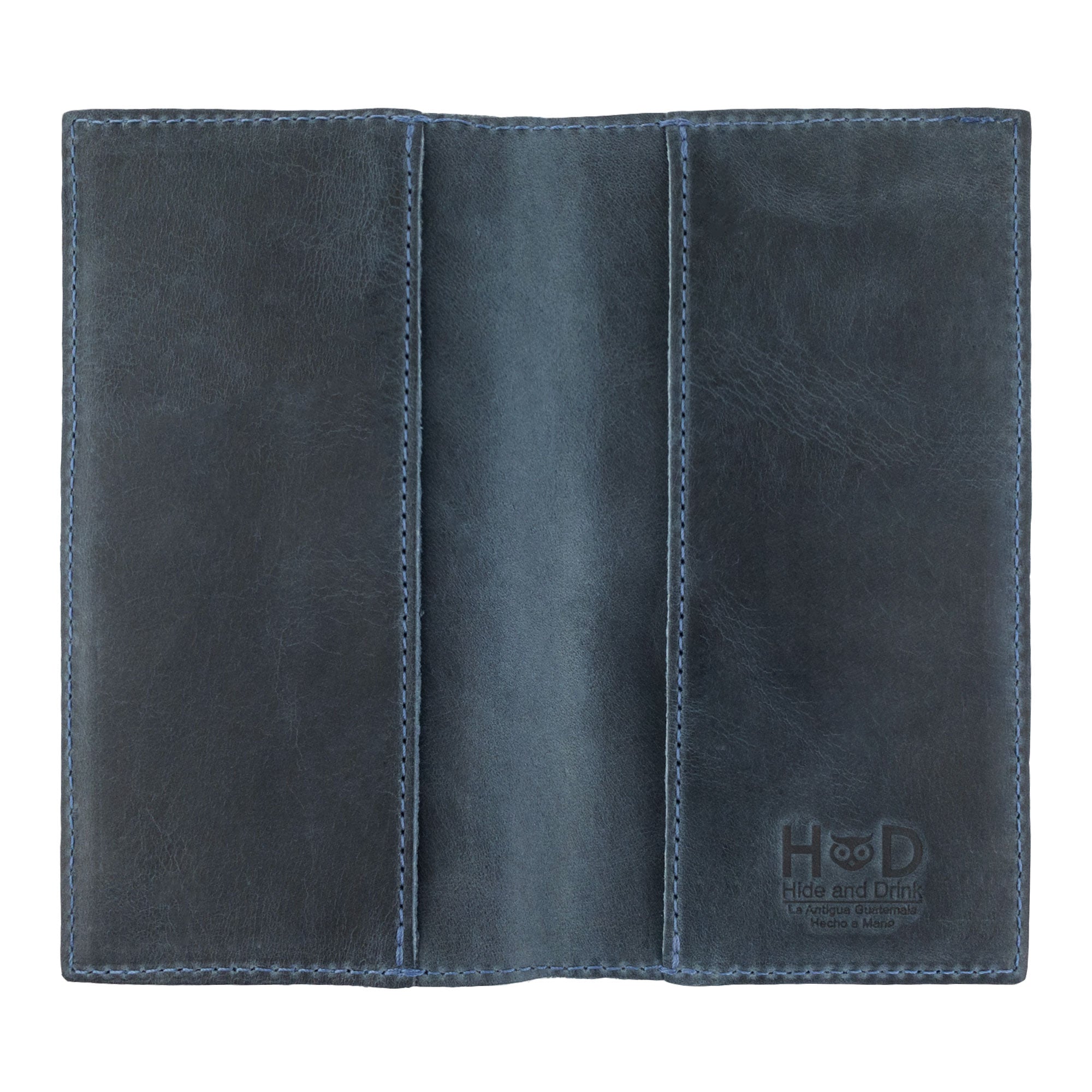 Open design of the brown Checkbook Leather Cover by Hide & Drink, showcases its function as a minimalist organizer for standard checkbooks. Made from high-quality full grain leather, this handmade item reflects artisan craftsmanship from La Antigua Guatemala and Oaxaca Mexico, promoting small batch production.