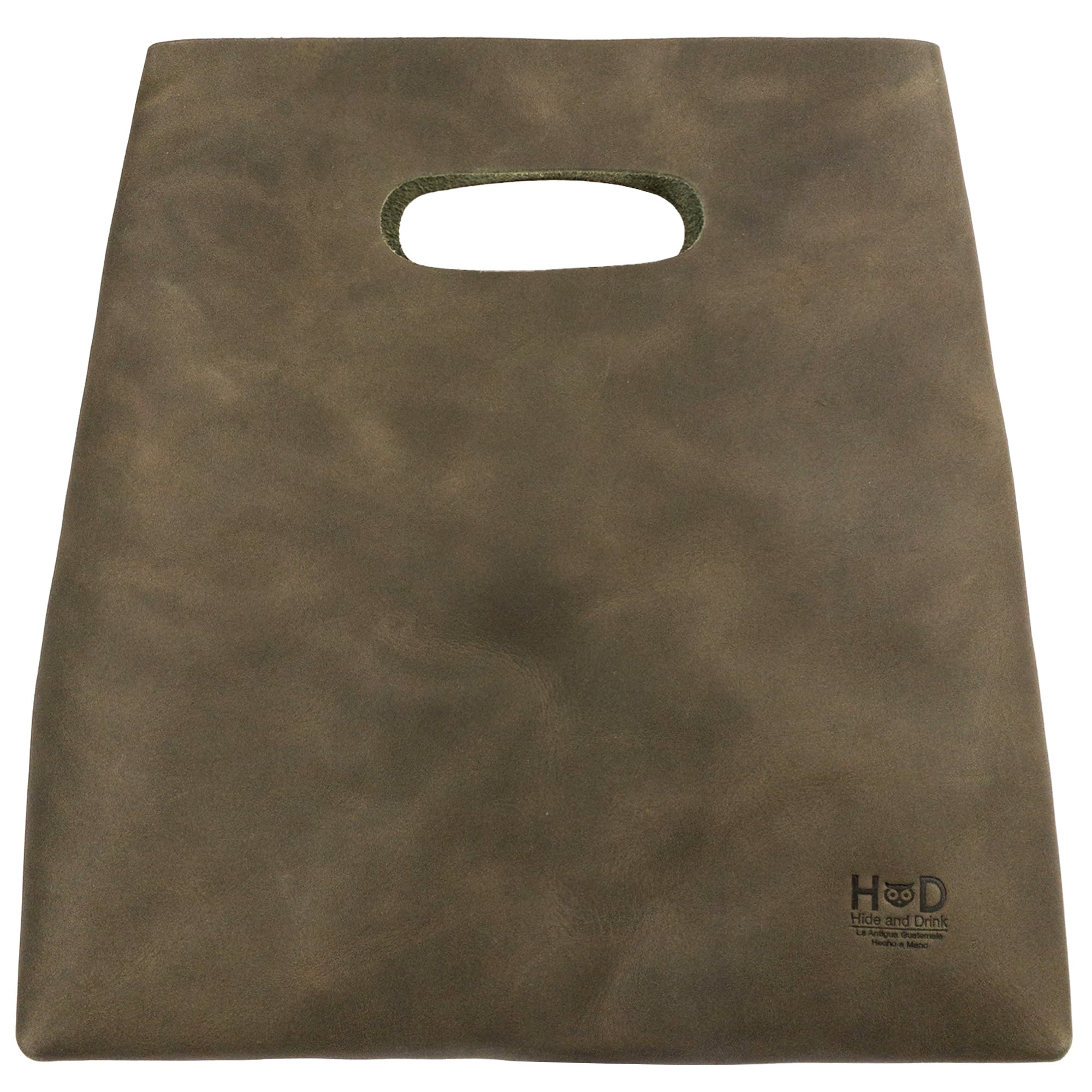 The top view of a Minimalist Boho Handbag by Hide & Drink, showcasing sleek design with a unique handle. This Minimalist Handbag for Women serves as a stylish Tote Bag, made from rustic Full Grain Leather, representing StockyardX's commitment to Small Batch Production, Hand Cut, and Hand Sewn craftsmanship, reflecting artisan work from La Antigua Guatemala & Oaxaca Mexico.