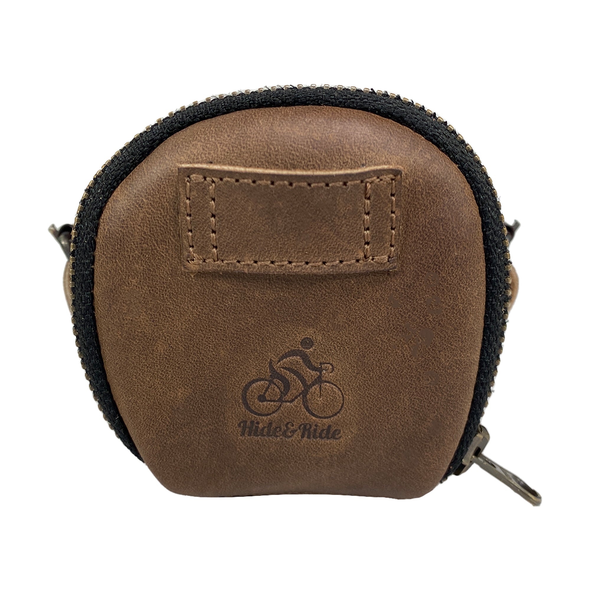 Front view of the Hide & Ride Under Seat Pouch, featuring the logo on its smooth full grain leather surface. This Bicycle Under Seat Pouch serves as a versatile accessory bag for bikers. It emphasizes the attributes of a multi-functional organizer for commuters, crafted through small batch production with artisan skills from La Antigua Guatemala & Oaxaca Mexico.