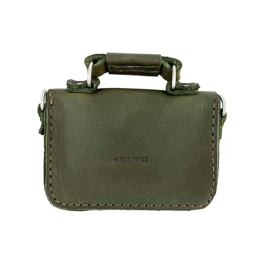 Interior view of Hide & Drink's Card Holder Briefcase Style, displaying the green suede lining of the Mini Briefcase Card Holder. Handcrafted from Full Grain Leather, this case is designed to hold up to 10 cards plus folded bills, efficiently serving as a cash organizer.