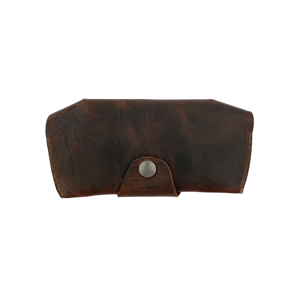 Back view of the Foldable Sunglass Case by Hide & Drink, featuring a secure closure. This artisan-quality case is handcrafted from Full Grain Leather, highlighting small batch production and hand sewn details for a unique touch.