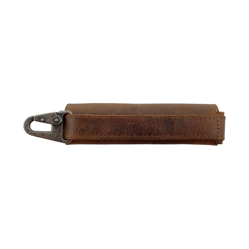 Side view of the Harmonica Case by Hide & Drink, crafted from full grain leather. This musician accessory offers a secure closure and durable design, making it a reliable instrument cover for any harmonica player. Handmade in La Antigua Guatemala, showcasing artisan craftsmanship.