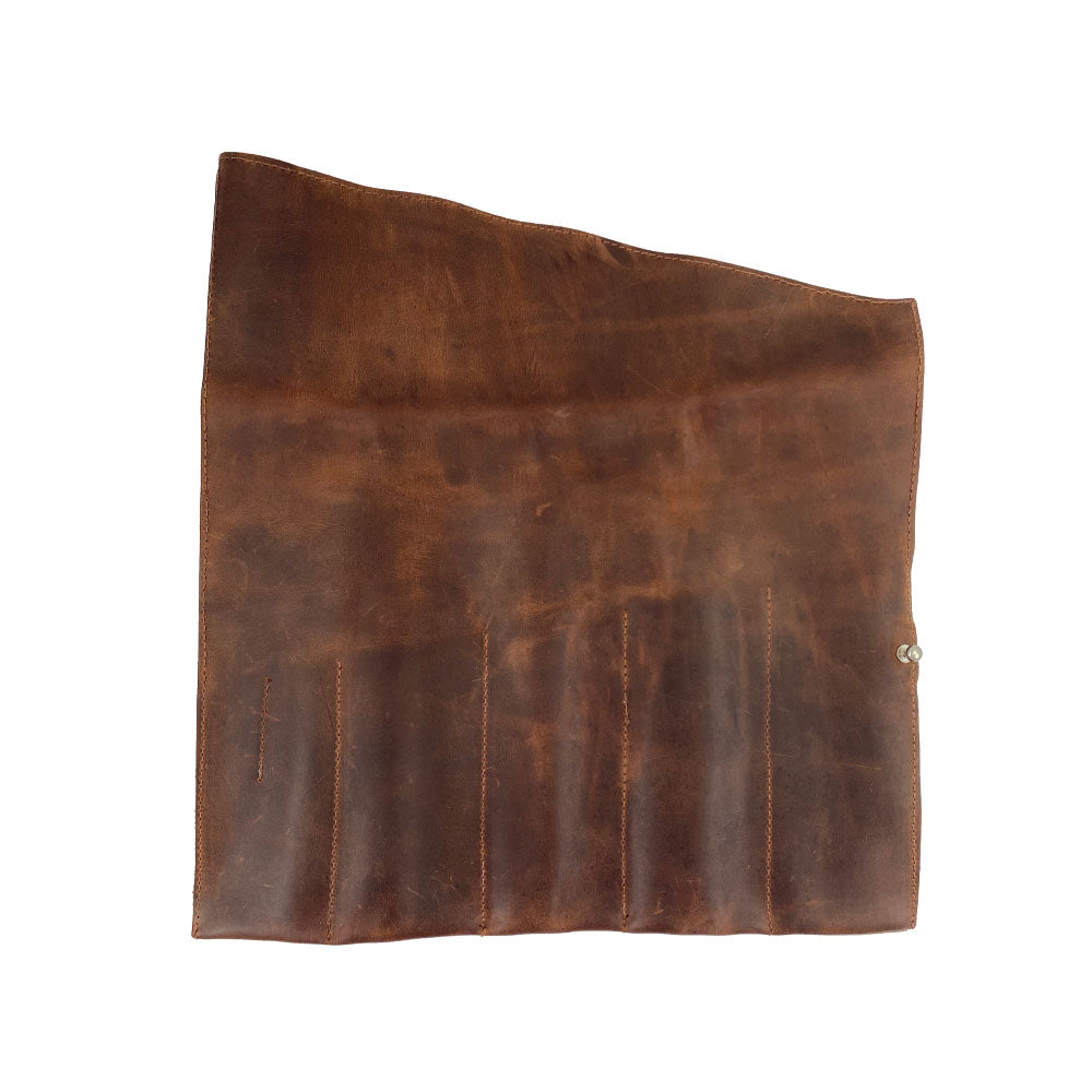 An elegant Large Tool Roll by Hide & Drink featuring a full grain leather finish. This portable carry-on pouch provides 6 slots ideal for woodworking tools organization. Crafted from durable waxed canvas & leather variations, it's a small batch production piece, hand cut and sewn by artisans in La Antigua Guatemala & Oaxaca Mexico.