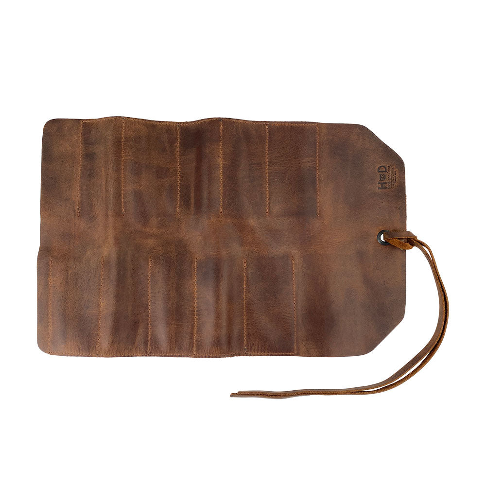 Hide & Drink Tool Roll, a versatile small tool roll-up bag featuring 10 slots, made from high-quality full grain leather. This portable carry-on pouch serves as an efficient woodworking tools organizer, complementing your workshop storage. Emphasizing artisan craftsmanship, it is hand cut, hand sewn, and proudly produced in La Antigua Guatemala & Oaxaca Mexico.