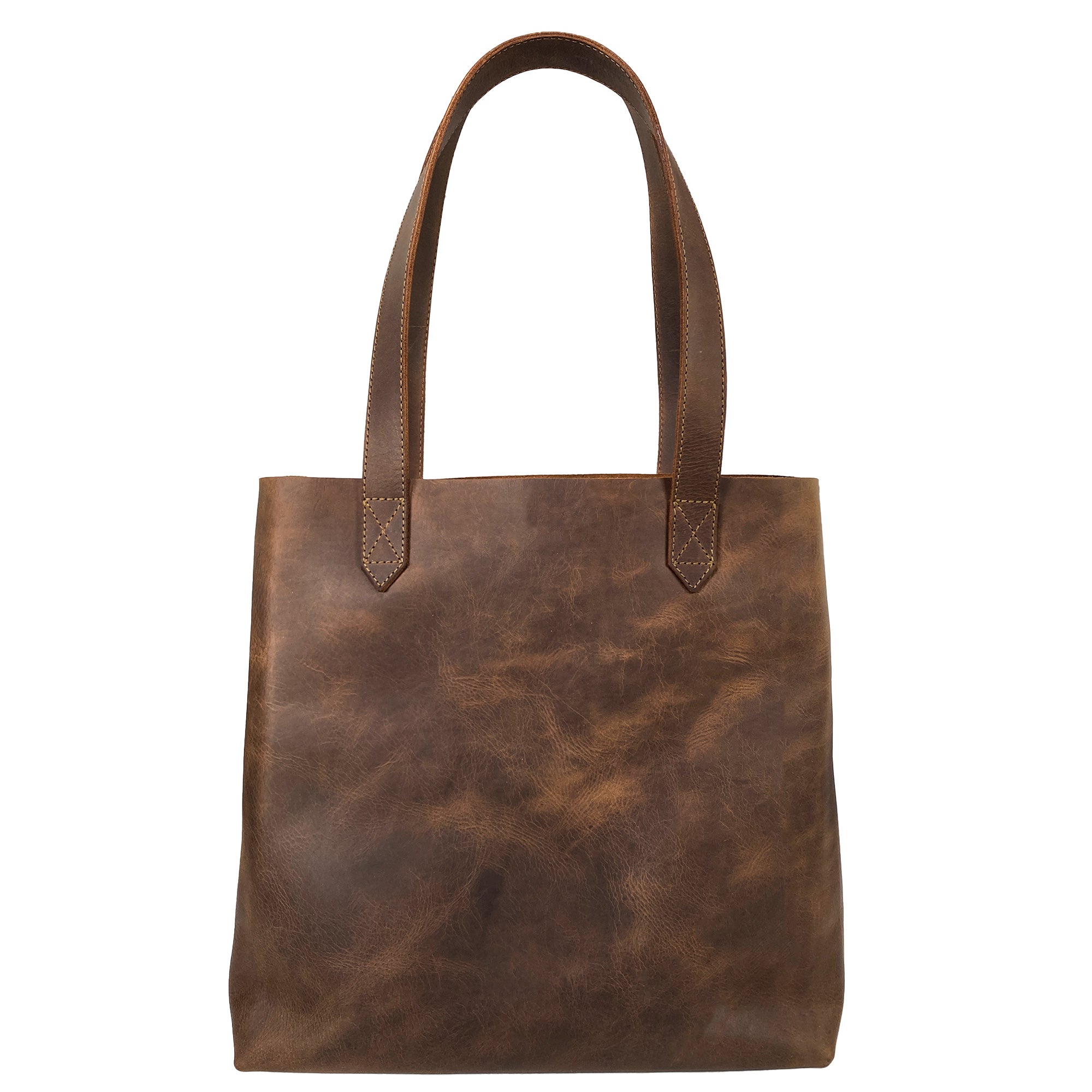 Heather's Classic Tote Bag displaying a chic shoulder bag silhouette made from high-quality full grain leather. This handmade handbag is ideal for everyday use, capturing the essence of small batch production from Oaxaca Mexico.
