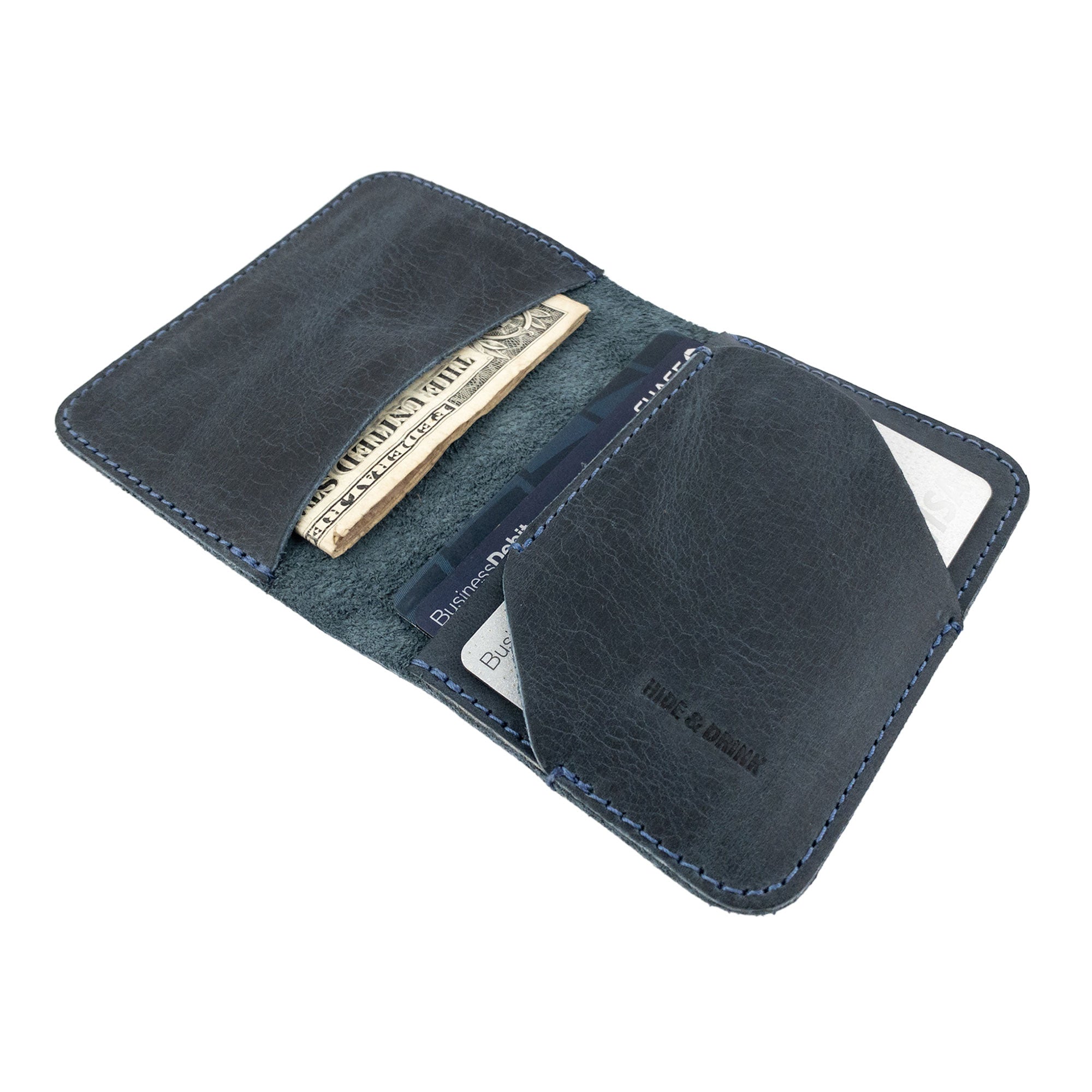 Bi-Fold Card Wallet Diagonal by Hide & Drink presenting a beautiful leather texture, demonstrating its capacity for cards and cash in a compact format.