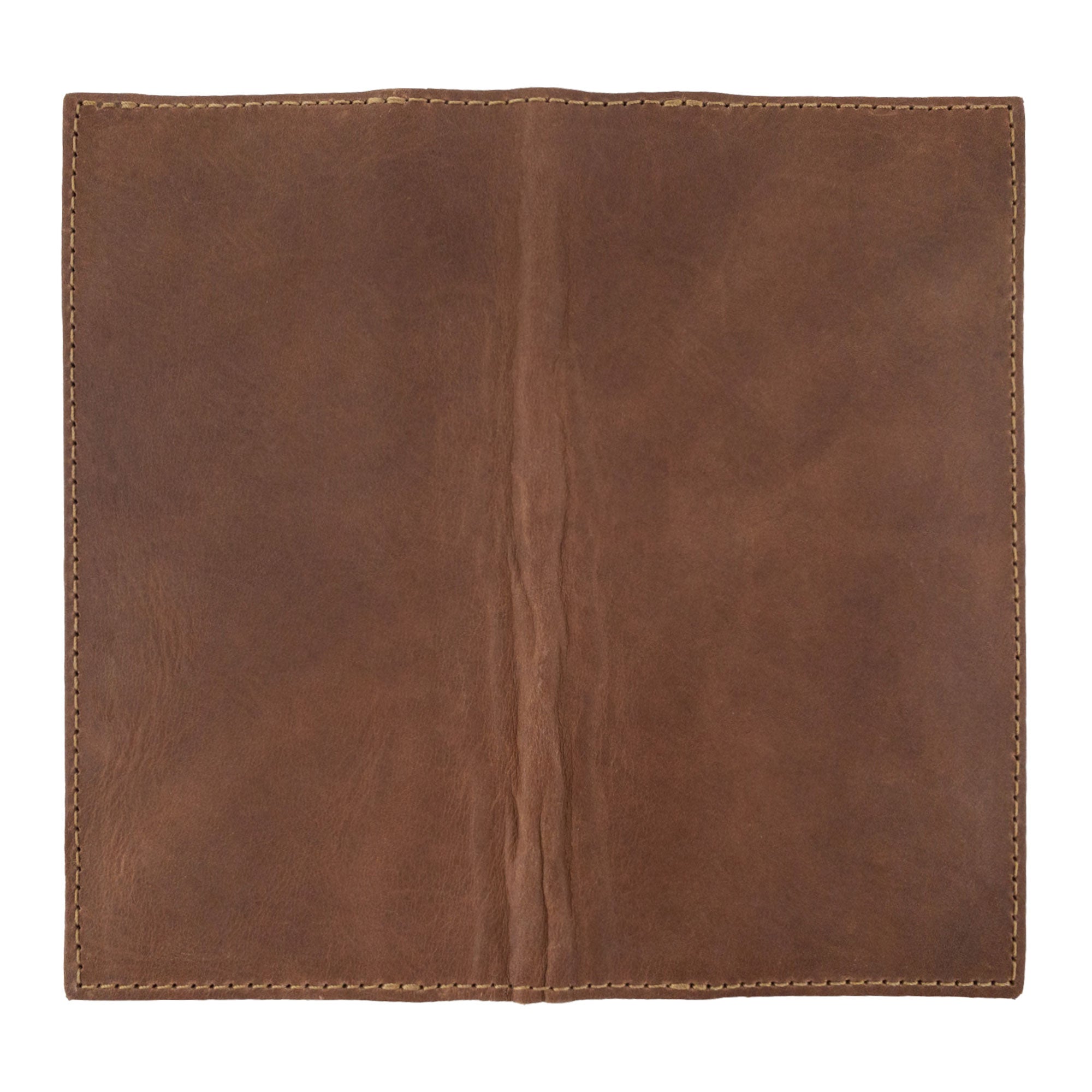 Inner view of the brown Checkbook Leather Cover by Hide & Drink, which works as a minimalist organizer for standard checkbooks. Made from full grain leather, this handcrafted piece showcases artisan skills from La Antigua Guatemala and Oaxaca Mexico, reflecting small batch production.
