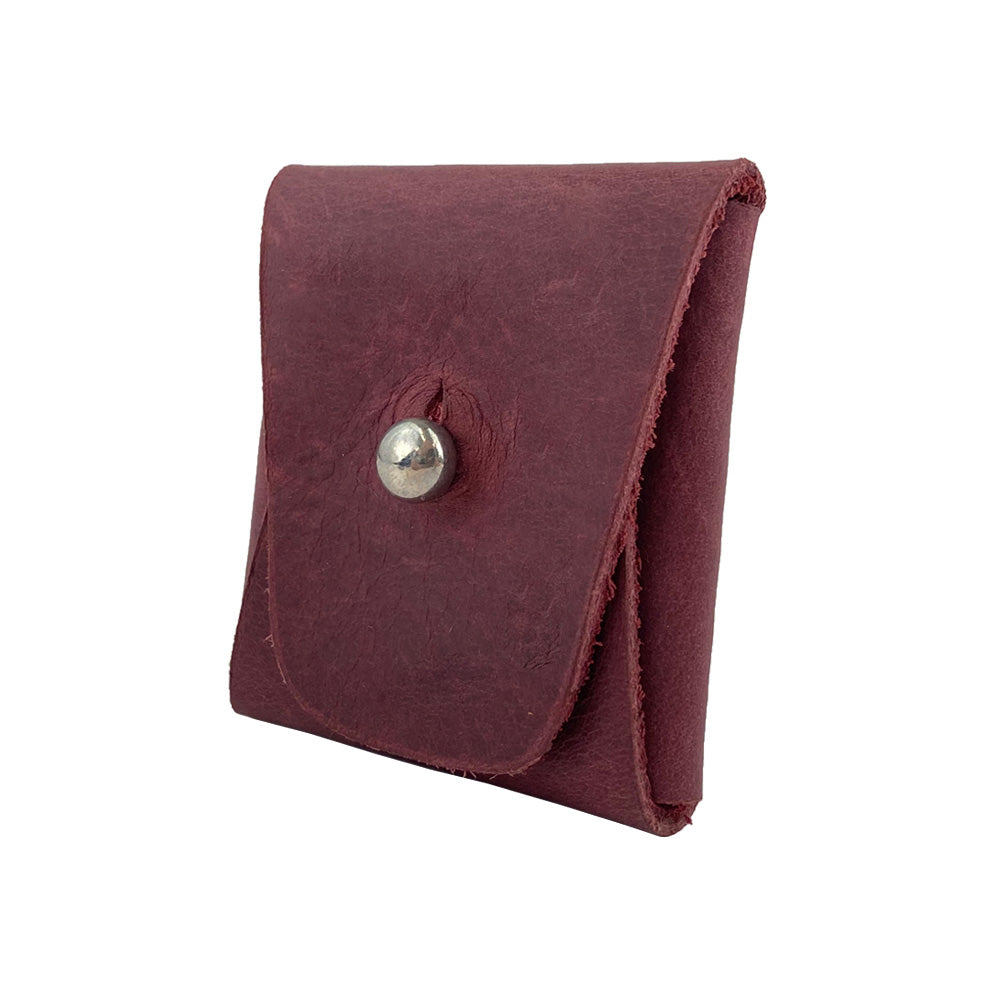 Side view of a burgundy Minimalist Square Coin Pouch by Hide & Drink, showcasing its compact design and secure snap closure. Handcrafted from durable full grain leather, this pouch blends style and practicality for daily use. Minimalist Coin Pouch, SD Card Holder, Wallet and Cash Organizer, Full Grain Leather, StockyardX, Small Batch Production, Hand Cut, Hand Sewn, Fire Branded, Artisan, Handmade in La Antigua Guatemala & Oaxaca Mexico.